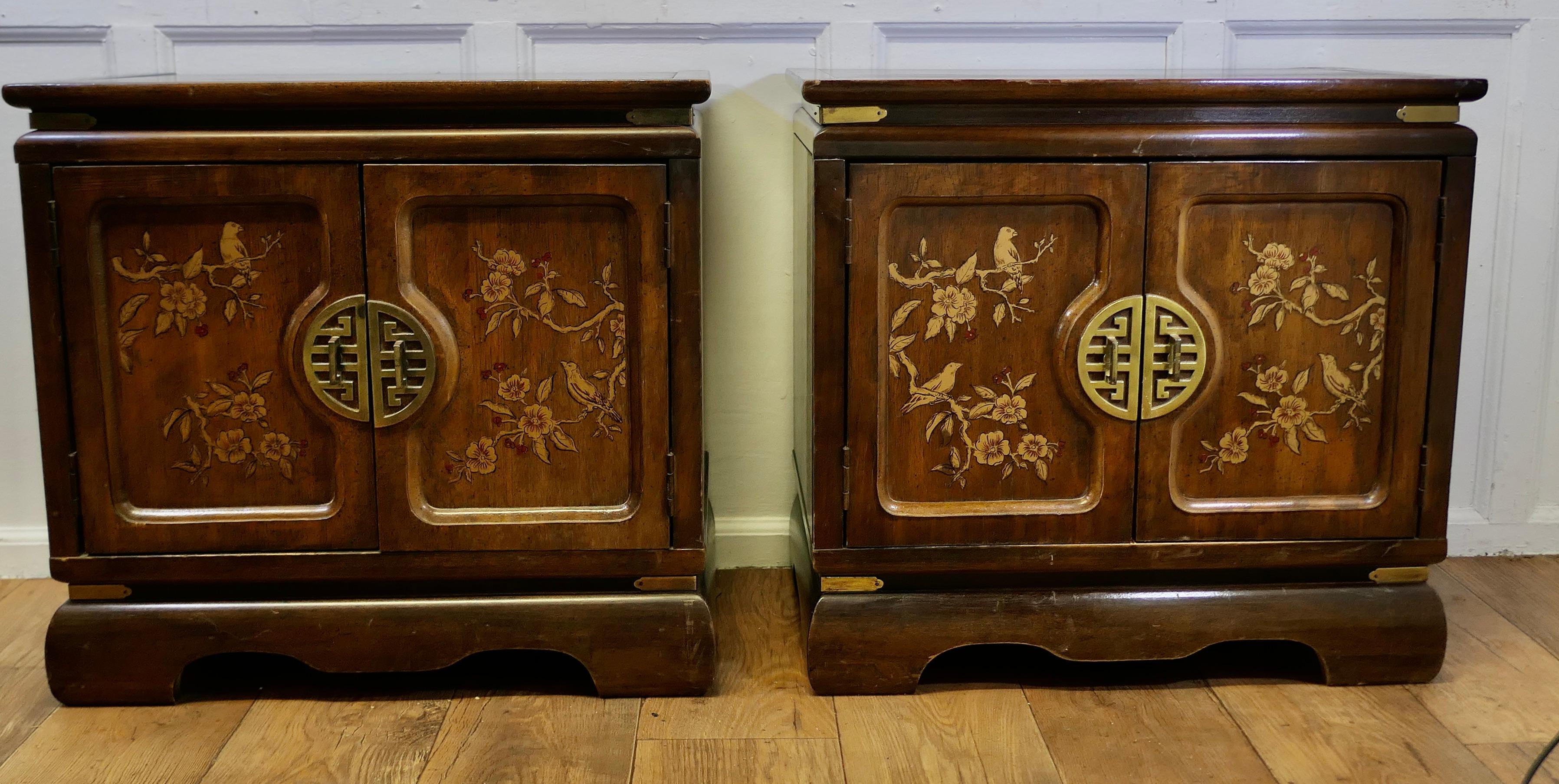 A Superb Pair of Chinoiserie Decorated Side Cabinets. 

A Prime example of chinoiserie decor with traditional Chinese illustrations on the front panelled doors with an elaborate Pin Lock on the front
Inside, they each have a shelf, both in good
