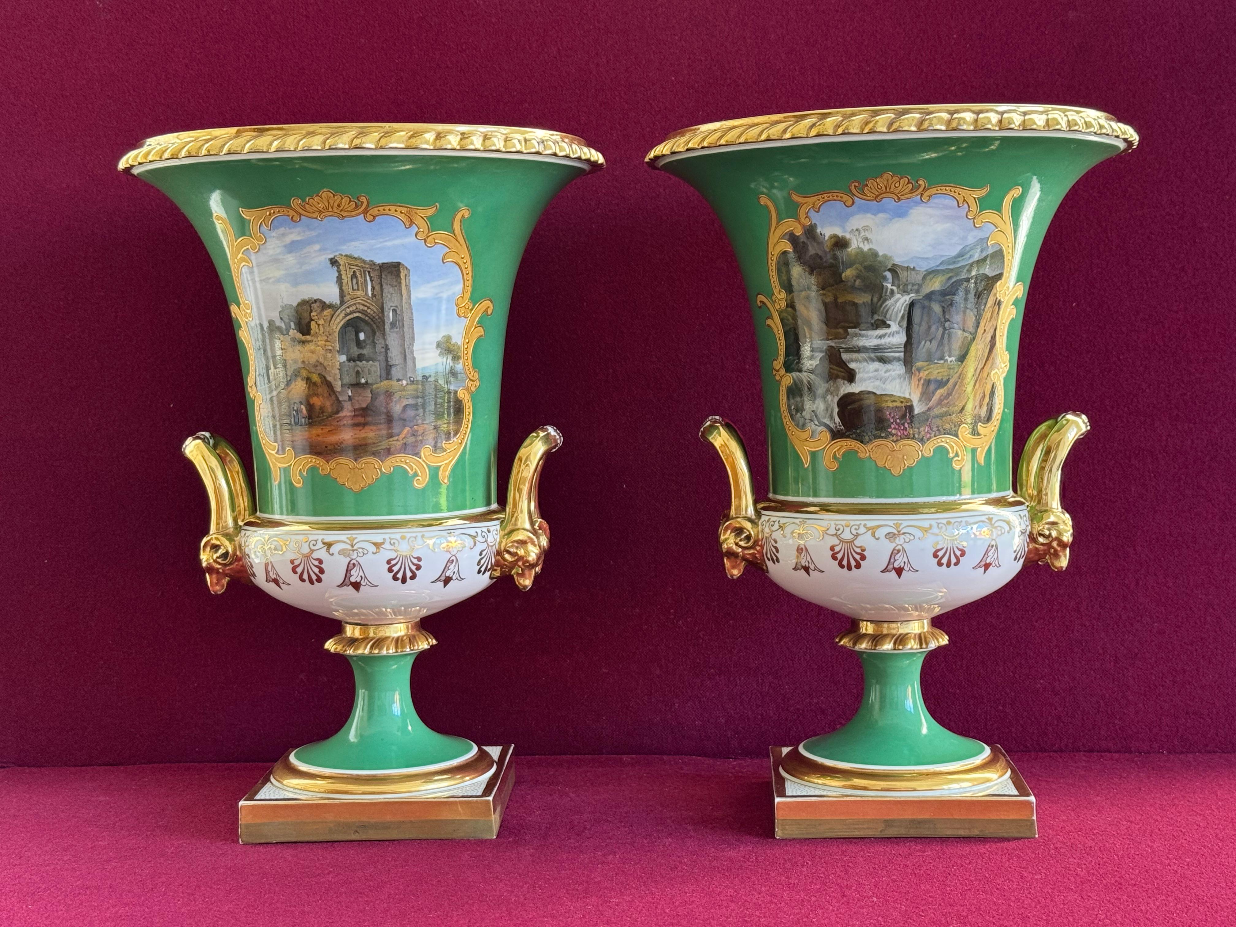 A superb and large pair of Flight, Barr and Barr Worcester porcelain vases c.1820. Of Campana form, with gilded gadrooned rims, each vase very finely painted with topographical views framed within raised paste gilded borders, one vase with a scene