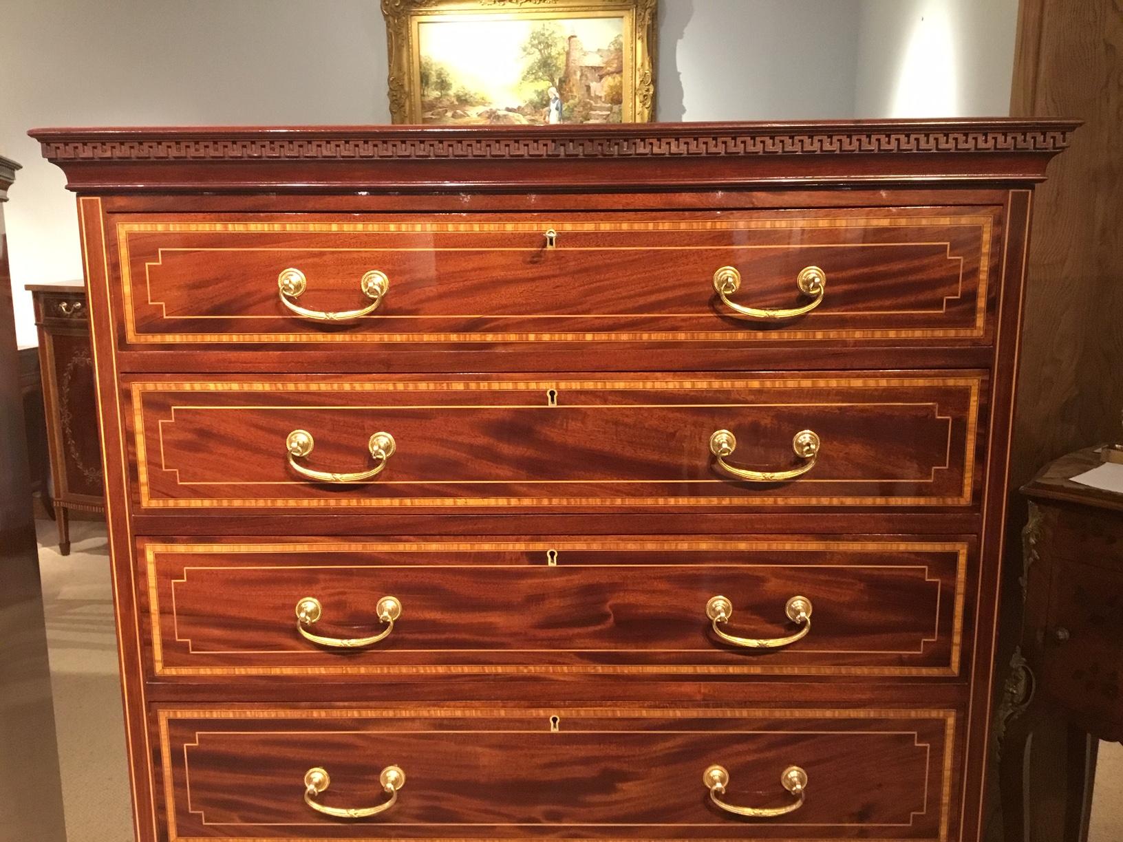A superb quality pair of Edwardian Period mahogany inlaid chests. Each constructed using the finest quality mahogany. Having solid mahogany tops with satinwood crossbanding above Greek key moulding to the frieze. Each chest has six graduating