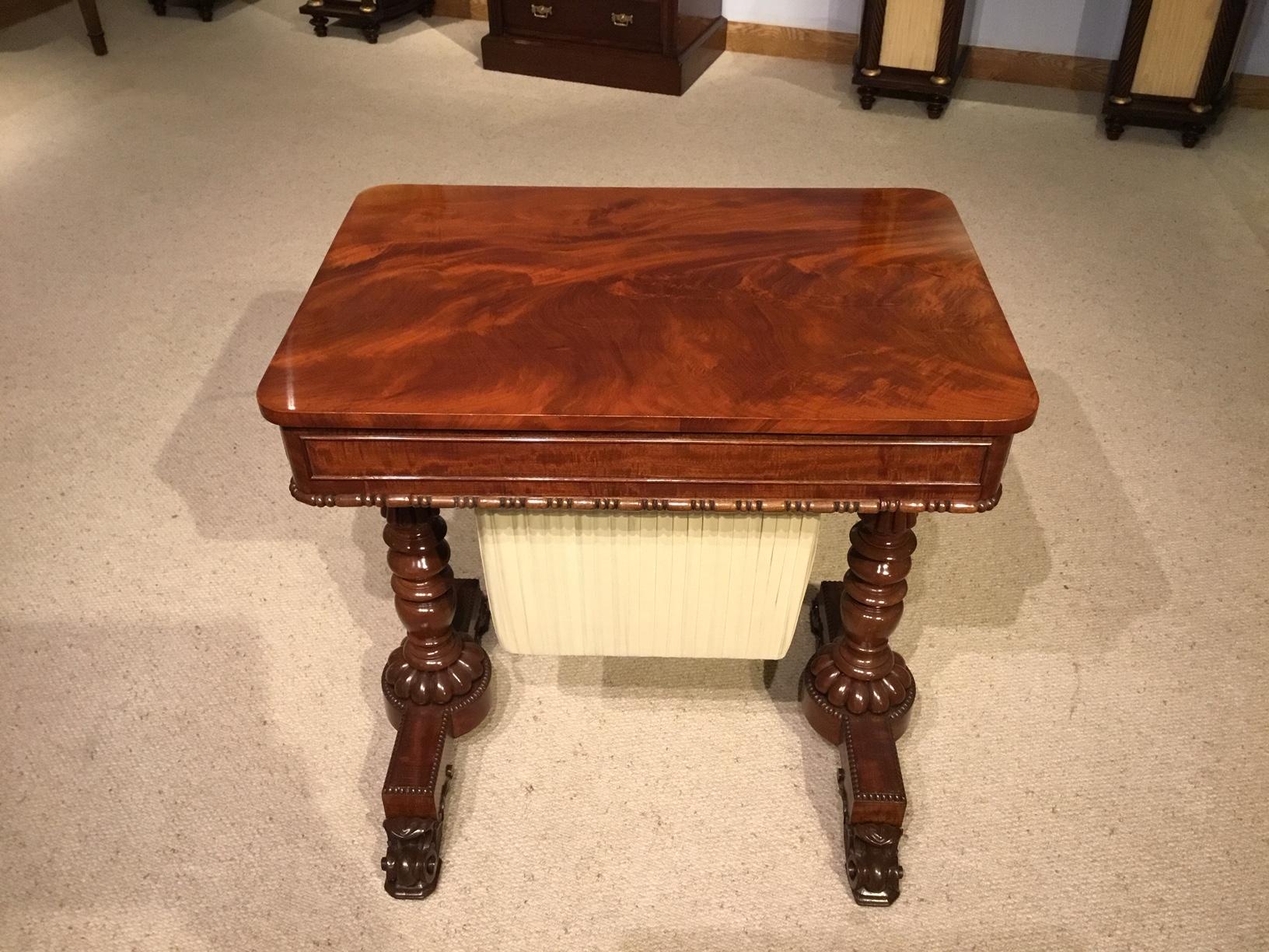 A superb Regency period flame mahogany antique work table. Having a rectangular top veneered in the finest flamed mahogany veneers which are repeated in the frieze and drawer fronts. With a mahogany lined drawer in each end, one fitted for sewing