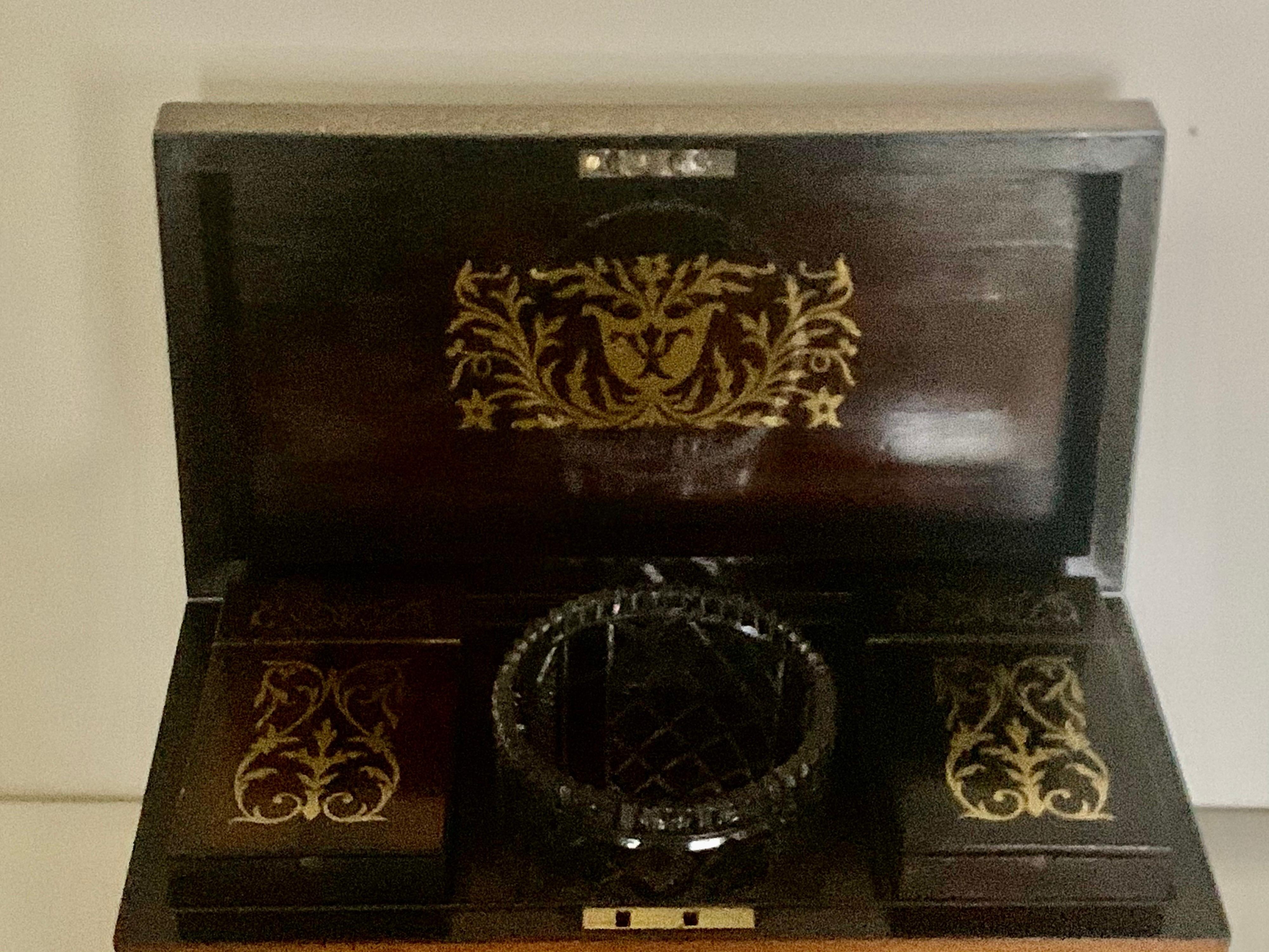 A fine regency brass inlaid rosewood twin canister tea caddy.
A lovely quality sarcophagus regency rosewood tea caddy dating to 1820, inlaid with a beautiful brass Foliate design to the top and front of the box. This fine tea caddy sits on four