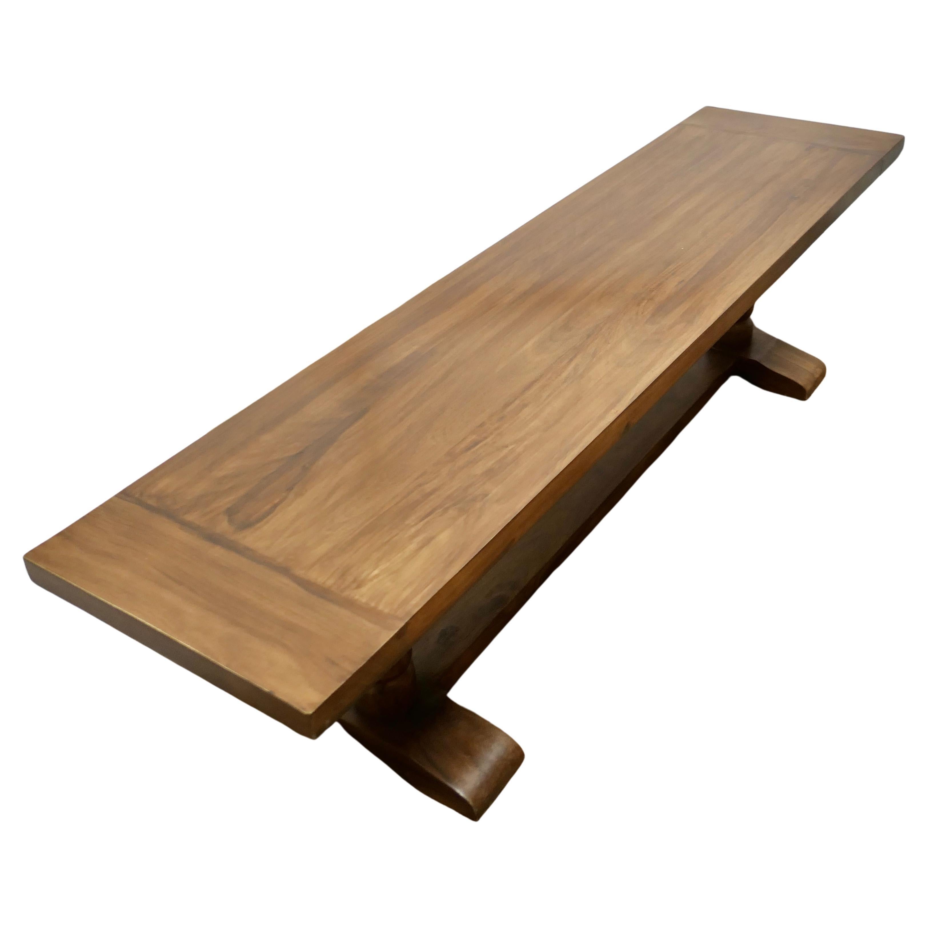 A Superb Very Long Walnut Coffee Table

This is a lovely looking piece it is very heavy and in the refectory style The Table has a 2” thick plank top, cleated at the ends and sturdy gun barrel legs 
The table is good and sound, it is very heavy and