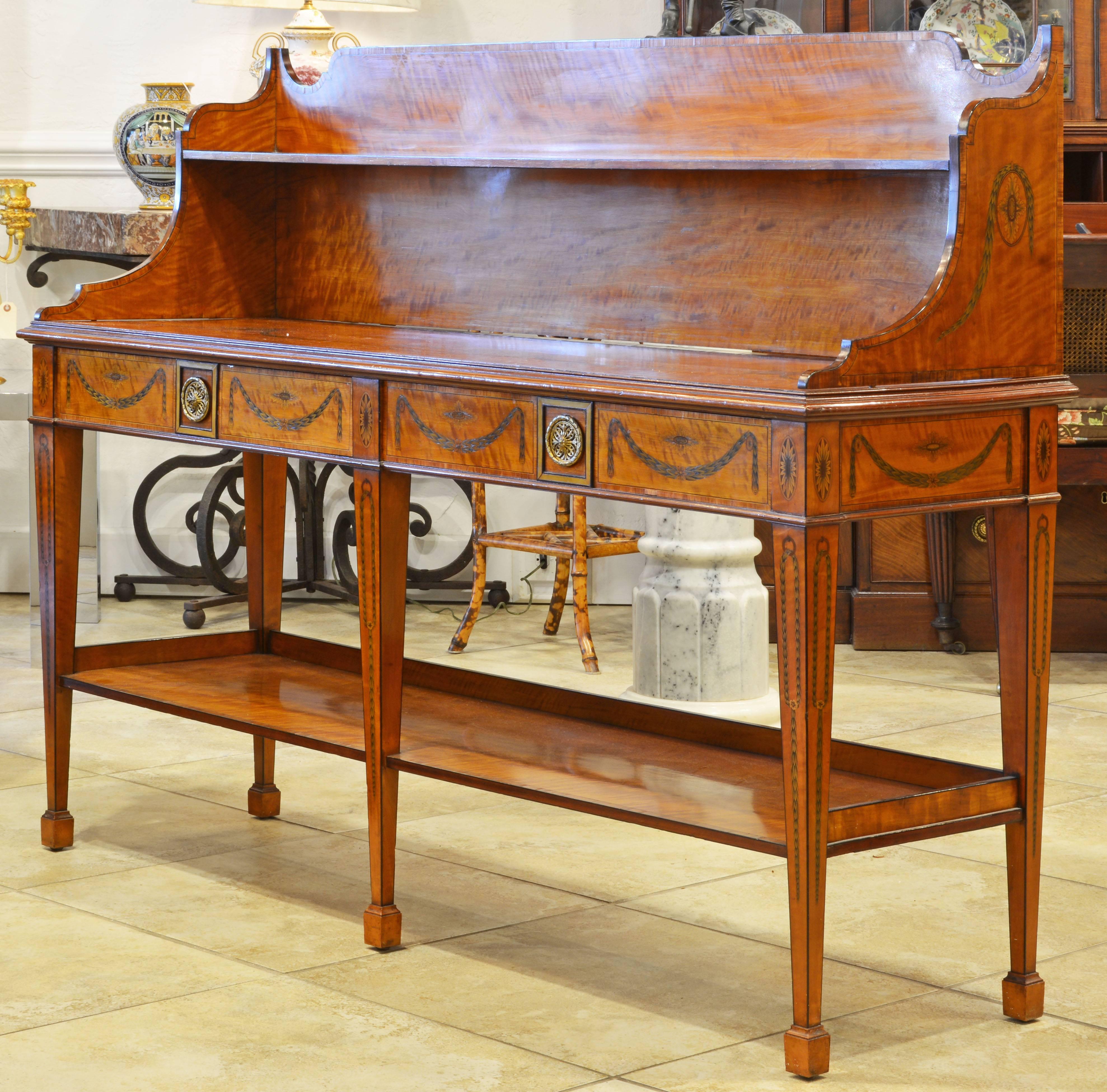 The incredible detail of the inlaid decorations with urns, garlands and sunbursts sets this exquisite piece of furniture apart. Fashioned in the Hepplewhite Adam style the server dated to the late 19th or early 20th century and is veneered with