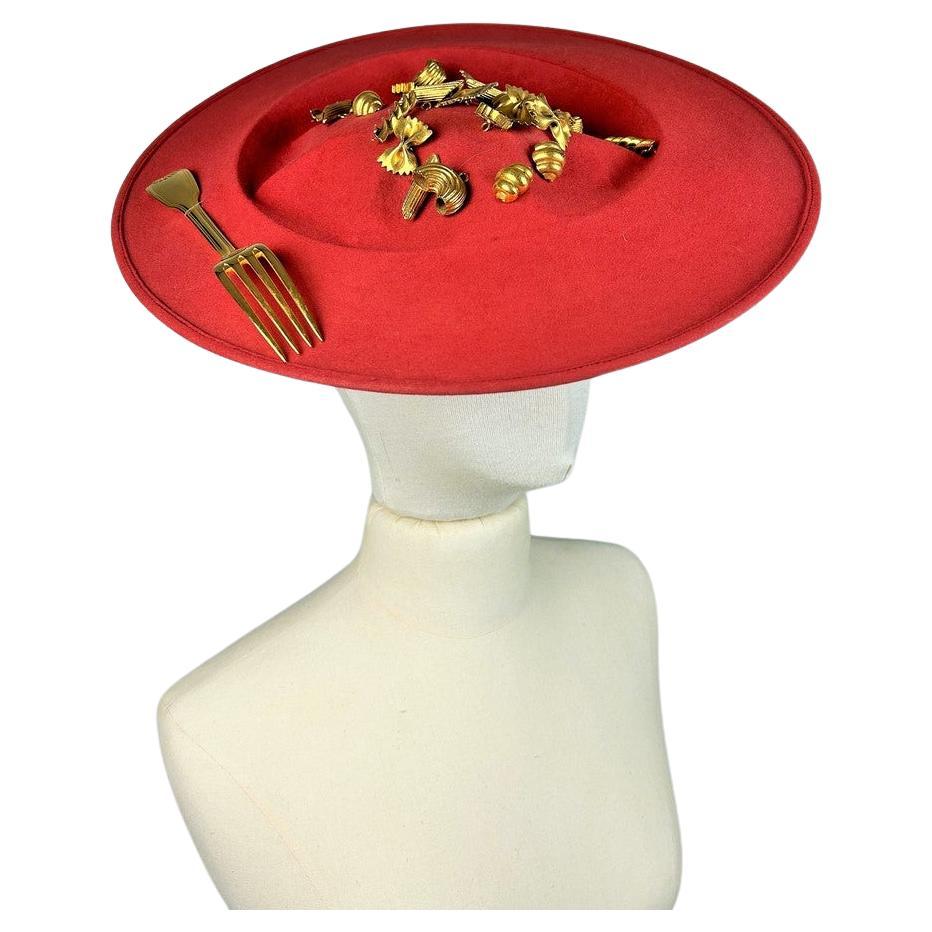 Circa 1980

France

A stunning scarlet wool felt Hat Capeline with Surrealist inspiration by French designer Isabel Canovas dating from the 1980s. Entitled déjeuner au Stresa (lunch in Stresa), this capeline is shaped like an oval plate filled with