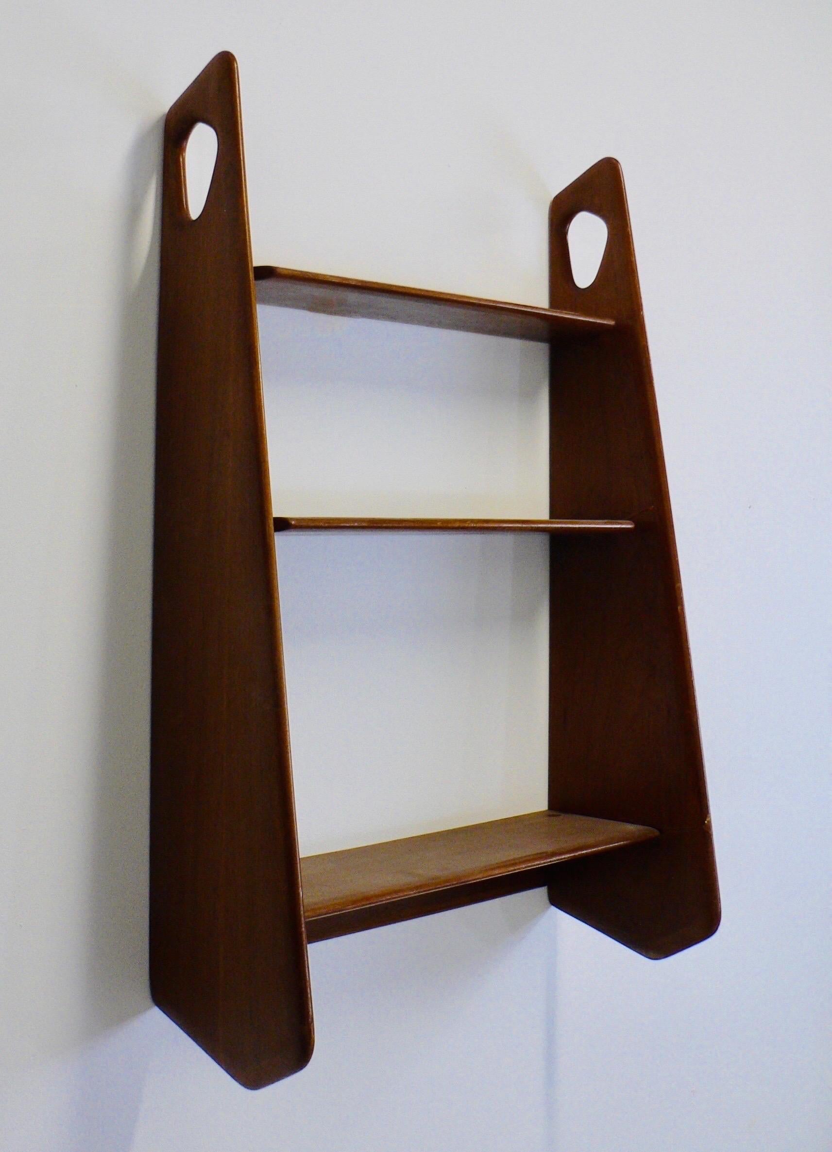 Rare suspended Teak Bookshelf from the 1950s, by Pierre Cruege for Éditions Formes.

In Perfect Condition, Typical French Design of the Era