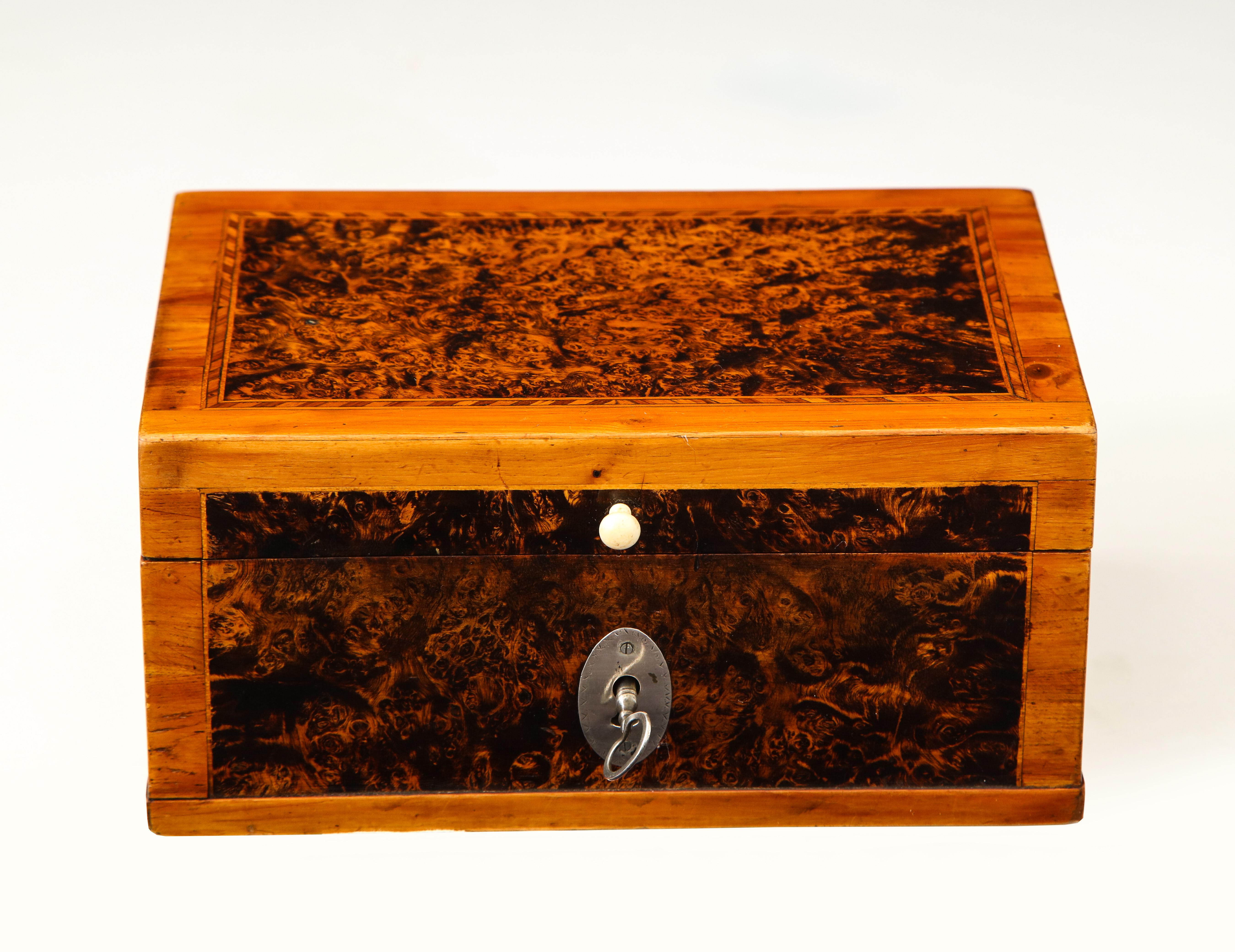A Swedish highly figured alder root and birch box, early 19th century, with a hinged lid and solid silver oval escutcheon and key.
Beautiful color and patina.
