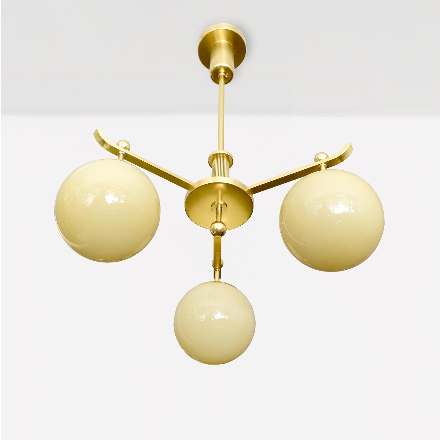 Polished A Swedish Art Deco polished 3-arm brass chandelier with glass globes. For Sale