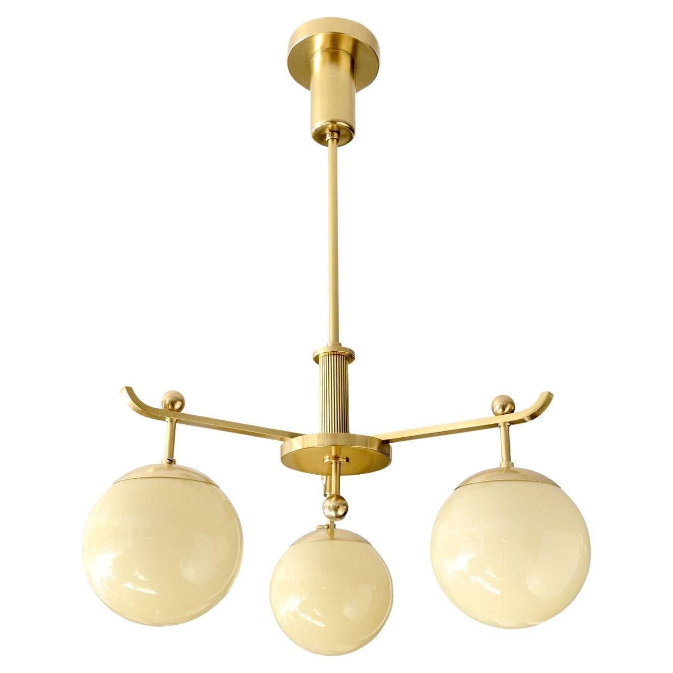 A Swedish Art Deco polished 3-arm brass chandelier with glass globes. For Sale