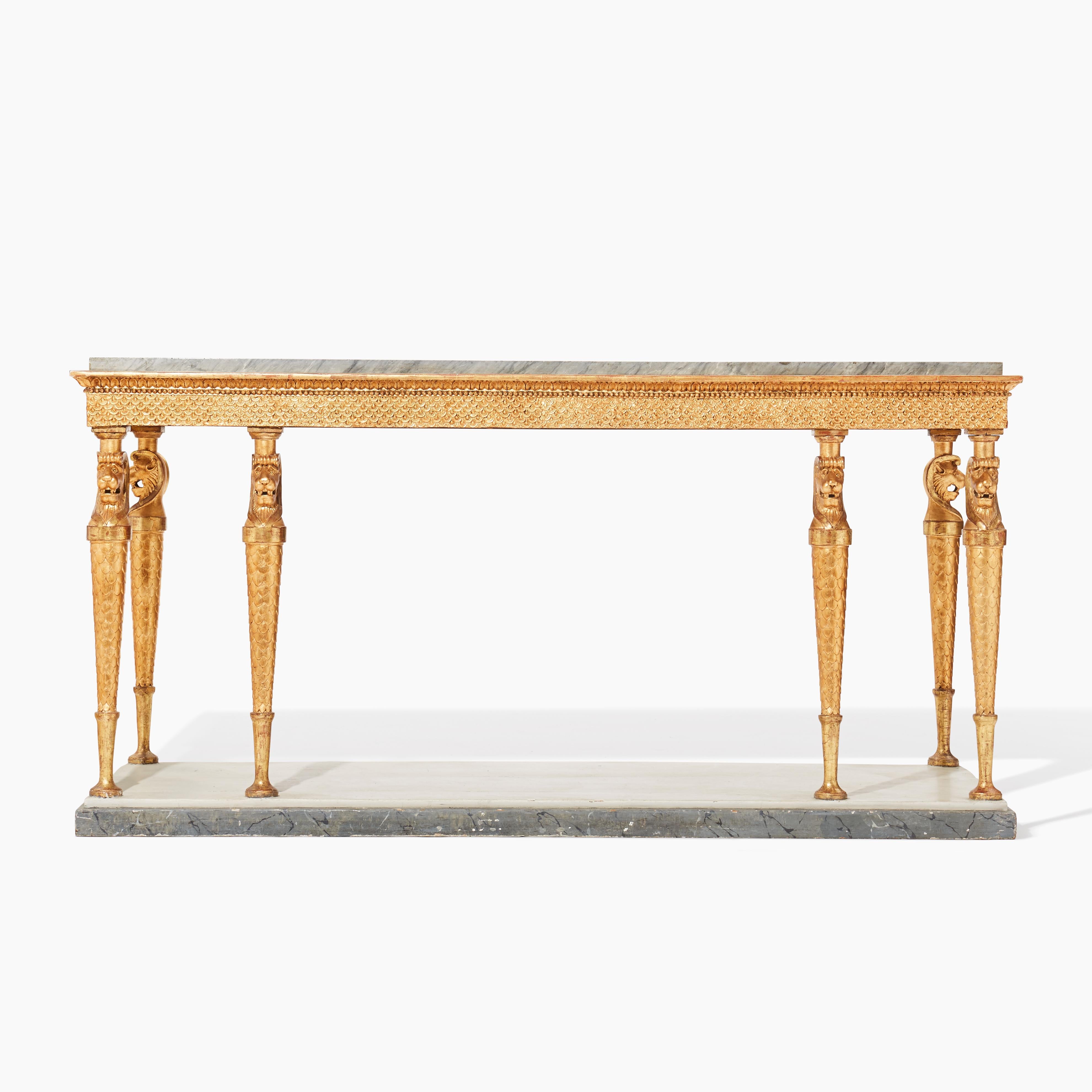 An impressive and very rare Swedish late gustavian/early empire eight leg gilt wood console/side table with a original light grey, bleu turquin marble top. Made by Jonas Frisk (1787-1849), Stockholm around 1810 after drawings by Carl Christoffer