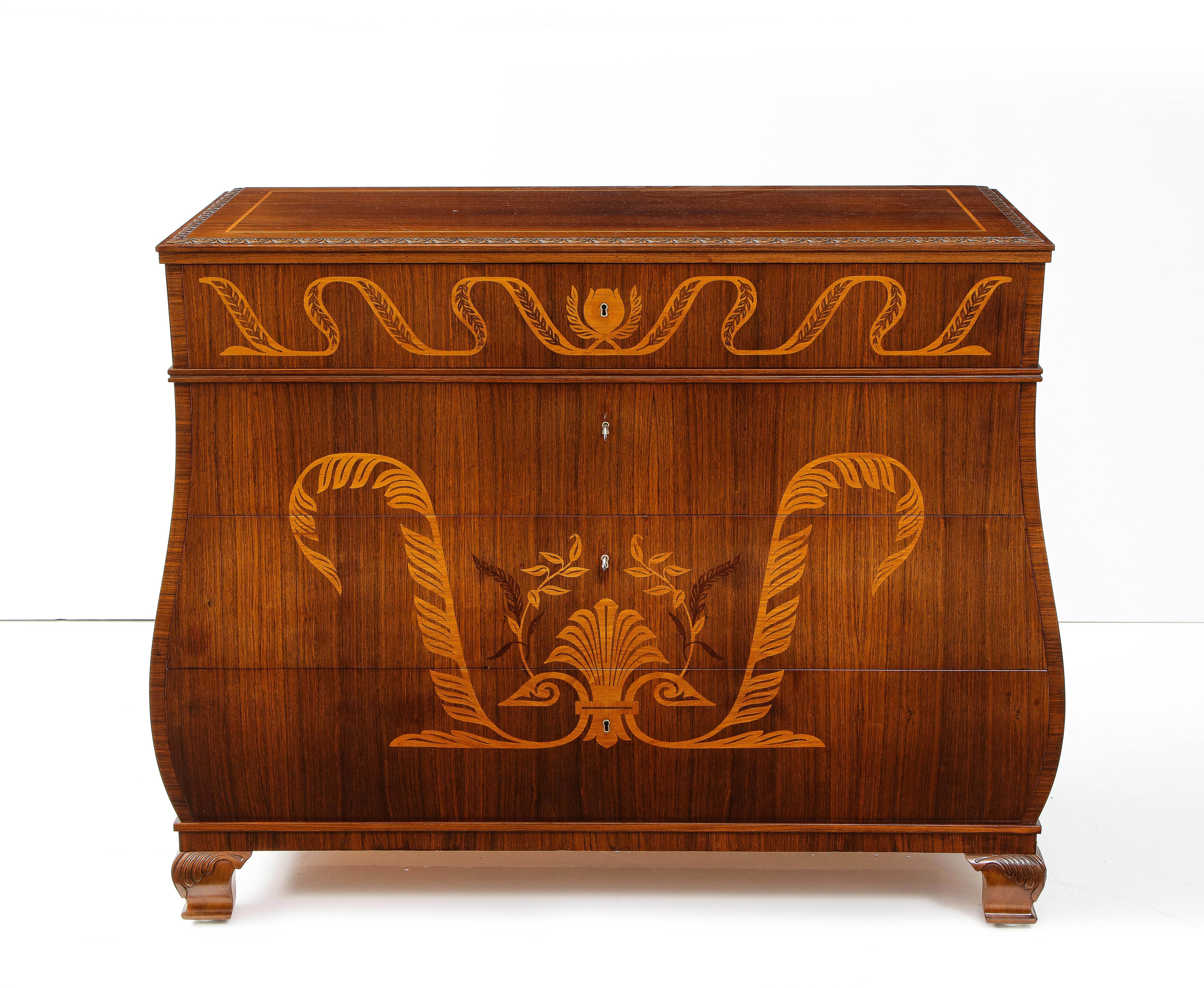 A fine Swedish Grace fruitwood inlaid rosewood chest of drawers, Circa 1930-40, the rectangular top with a leaf tip carved edge, the bombé form body with four shaped drawers elaborately inlaid with leaf and scroll fruitwood inlays. Raised on carved