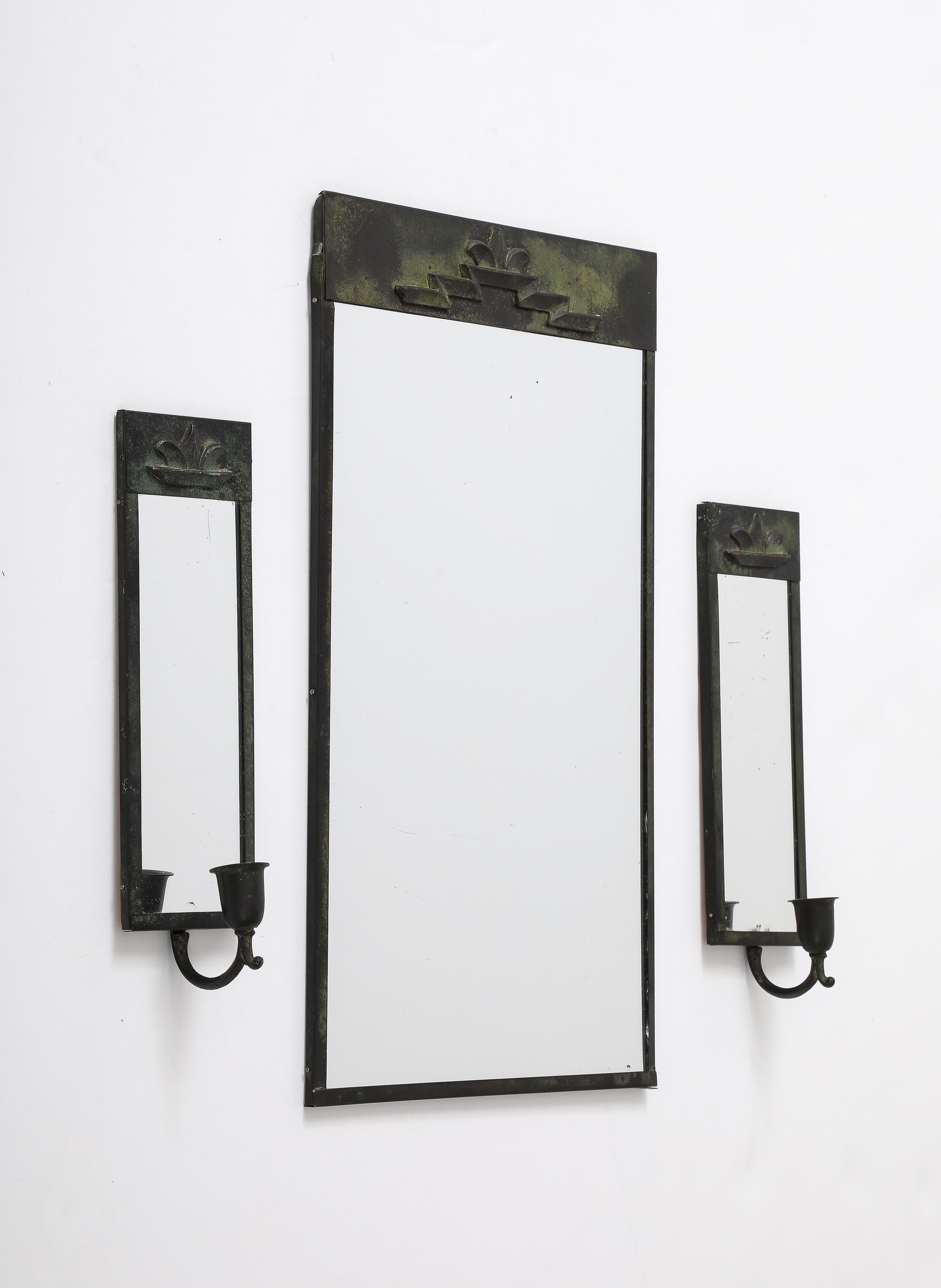 A Swedish Grace mirror and sconce group, Circa 1930, made in patinated metal to simulate bronze/copper. 

Mirror - 16 x 10 1/4in. Sconces - 9 3/4 x 3 3/8in.