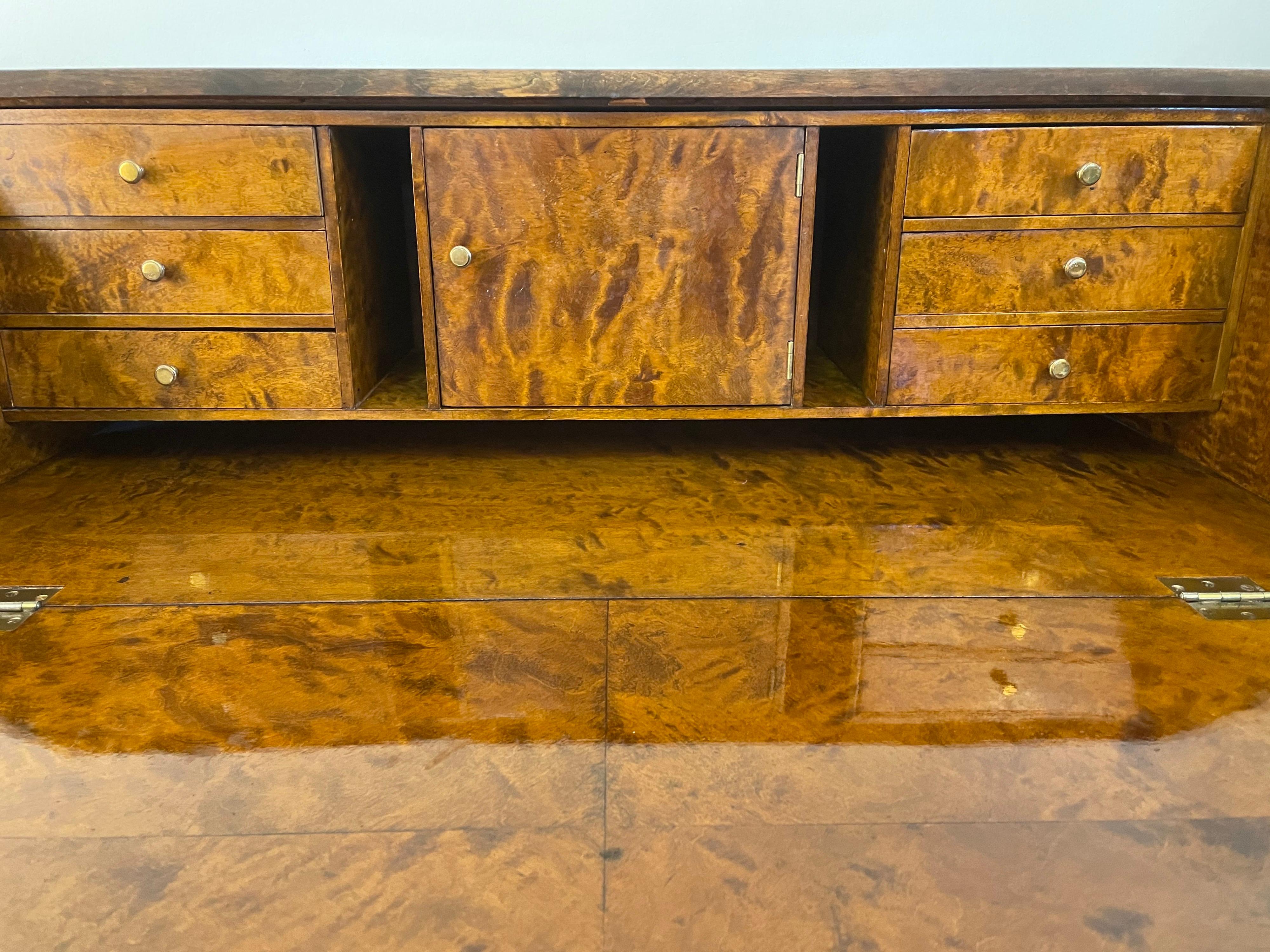 Grace was the inspiration for this lovely birch secretary which makes working from home a joy! Three locking drawers sit beneath a generous drop-front with 6 interior drawers, a pair of nooks, and a center cabinet, for organizing working materials,