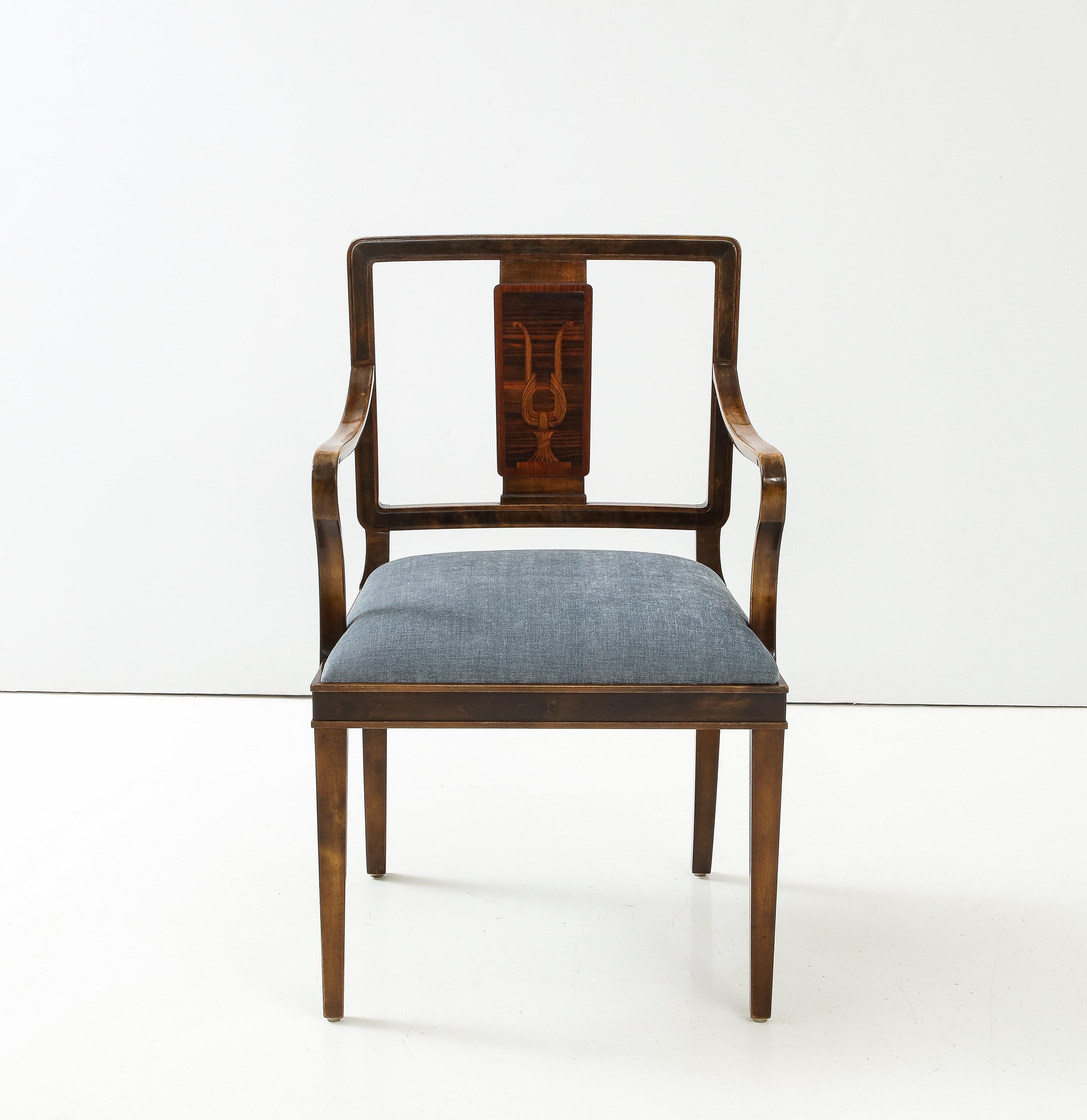 A Swedish Grace stained birch and inlaid open armchair, circa 1940s, probably designed by Carl Malmsten, with open rectangular backrests centered with neoclassical inspired inlaid back plat, curved armrests, drop-in upholstered seats, raised on