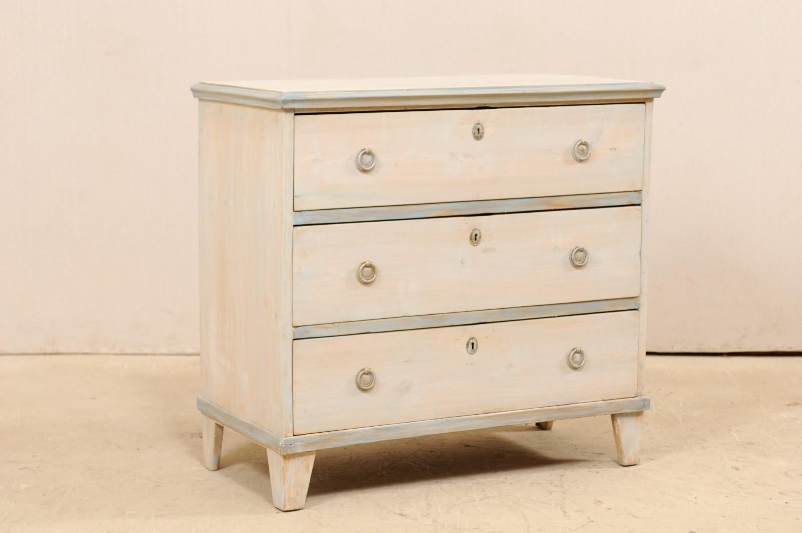 A Swedish Gustavian style painted wood chest from the mid-20th century. This vintage chest from Sweden, designed in typical Gustavian style, features a simple, clean design aesthetic. The rectangular-shaped top, with molded side trim, rests above a