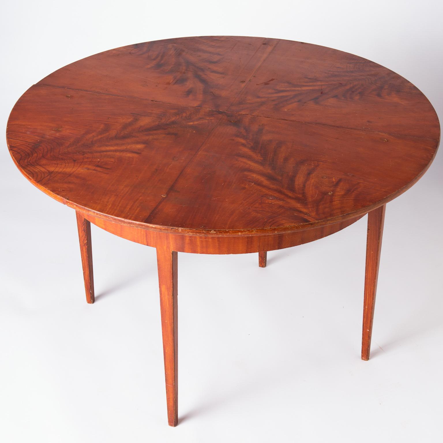 This spectacular table retains the original grain painting in a lovely pattern of feathery shapes emanating from the center. The condition of the paint is excellent with a few minor touch ups, but retains the original surface, showing the creativity