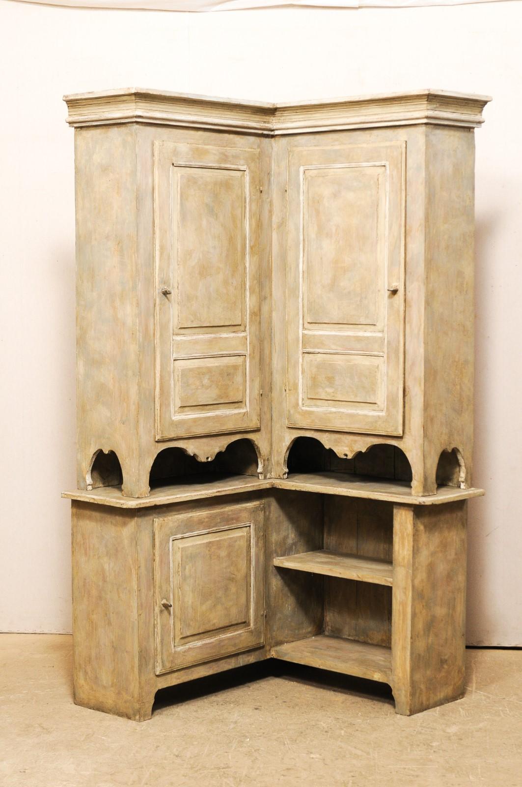 A Swedish Karl Johan period corner cabinet, circa 1850s. This mid-19th century cabinet from Sweden features a unique 90 degree angular design, taking advantage of corner space within a room. This upper case features a nicely molded cornice, has two