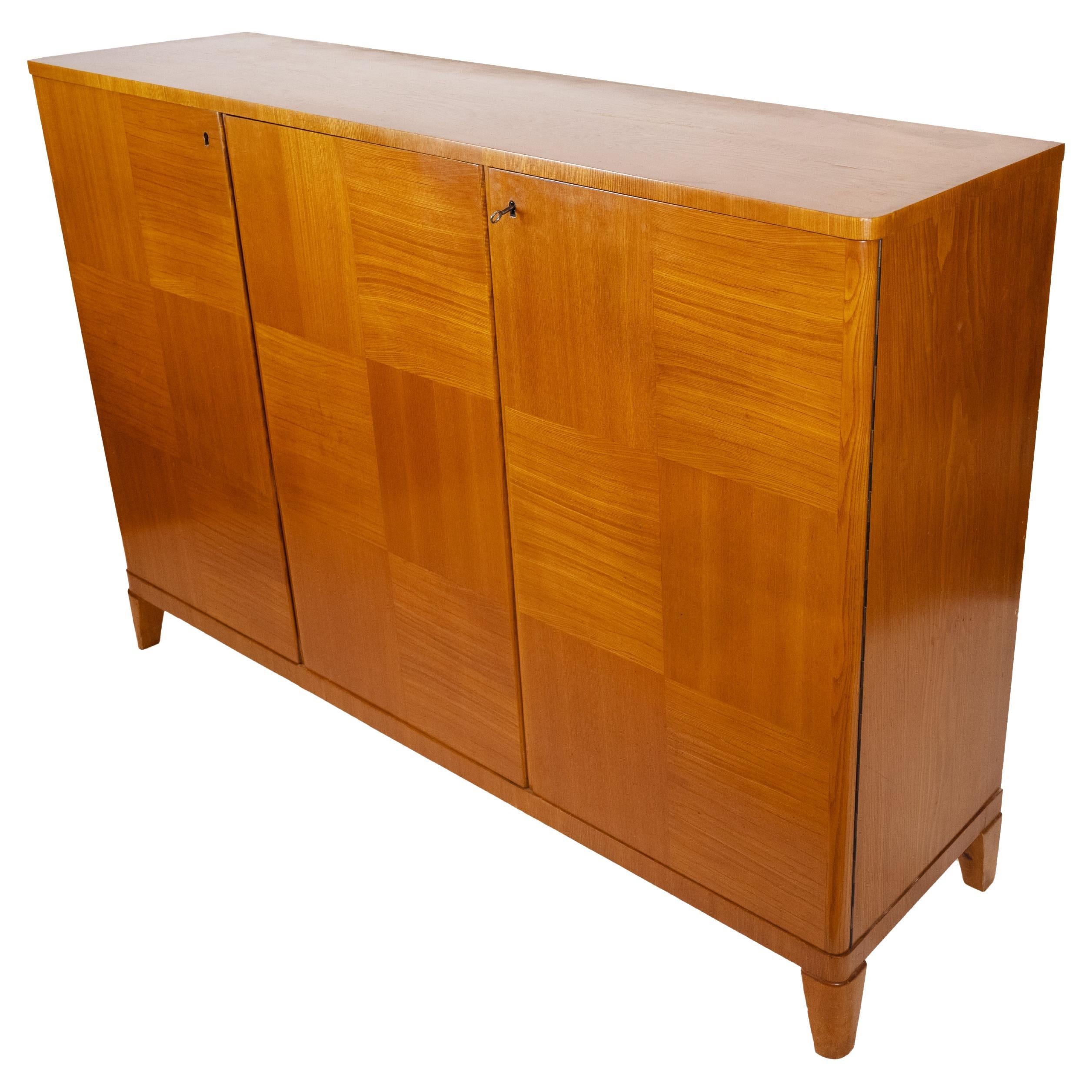 A Swedish Modern Cabinet With Contrasting Veneer