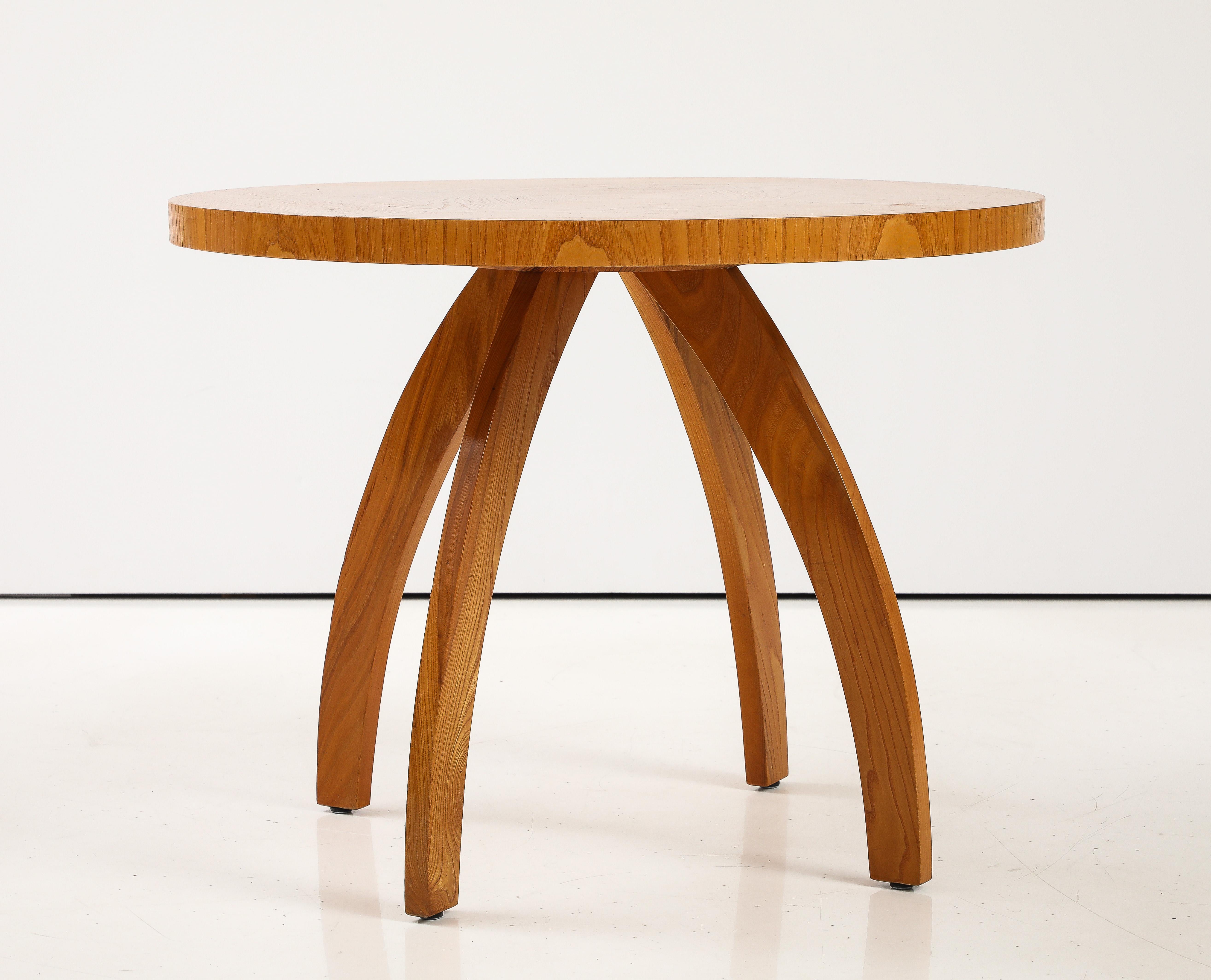 An interesting Swedish Modern elm side table, Circa 1940-50, the circular top with book matched elm veneer raised on four incurved legs. Owners name and dated on underside. 