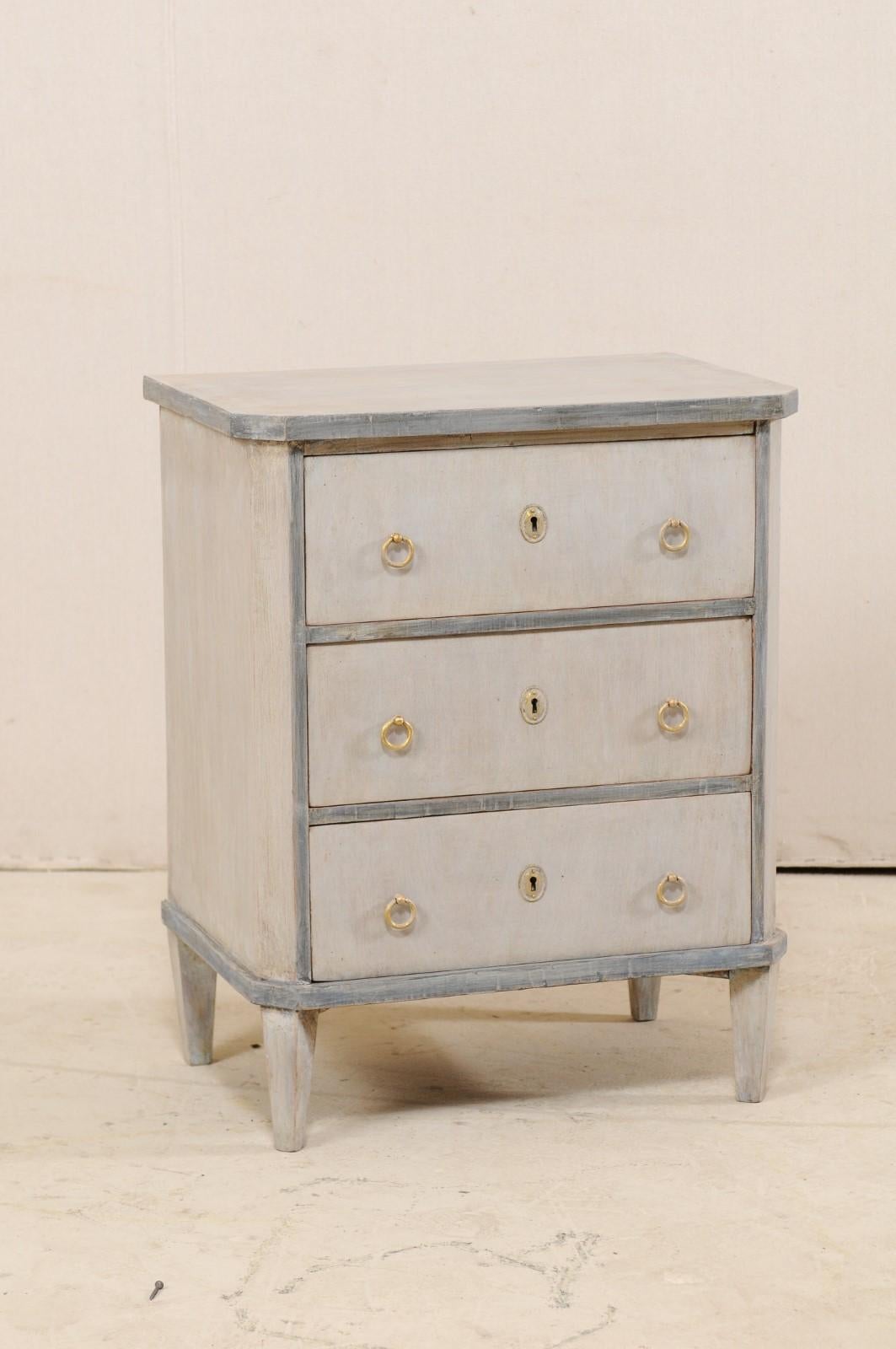 A Swedish period Gustavian petite-sized chest from the early 19th century. This antique chest from Sweden, in typical Gustavian style, features a simple, clean design with a slightly overhanging top, whose front corners are shaped to mimic the