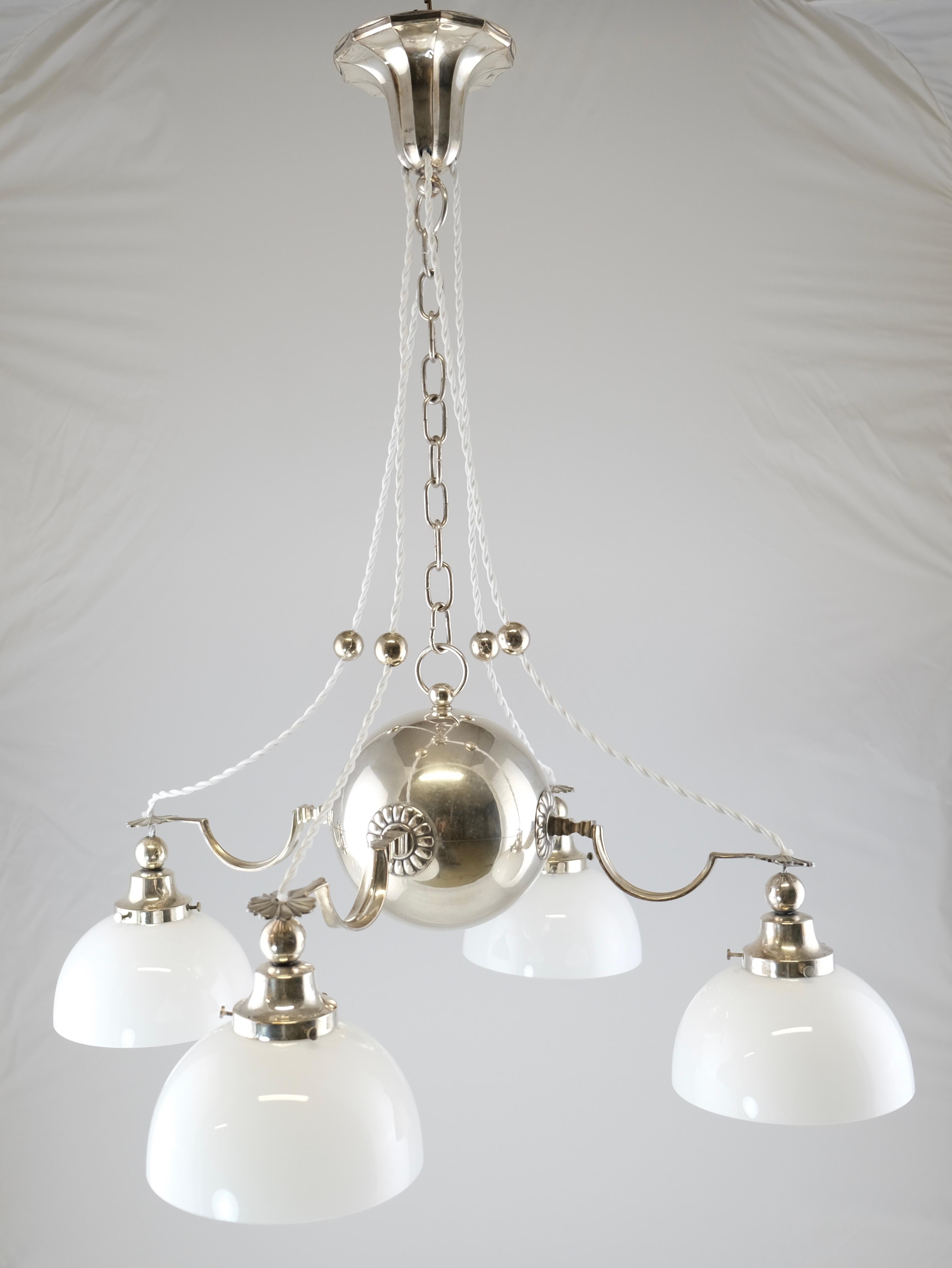 A silvered 4-light lamp made by C.G. Hallberg, Stockholm Sweden. Probably after a design by Elis Bergh. Signed. C G Hallberg under a crown.
Identical to the other one we have which can make it a pair if you need to. They came from the same estate