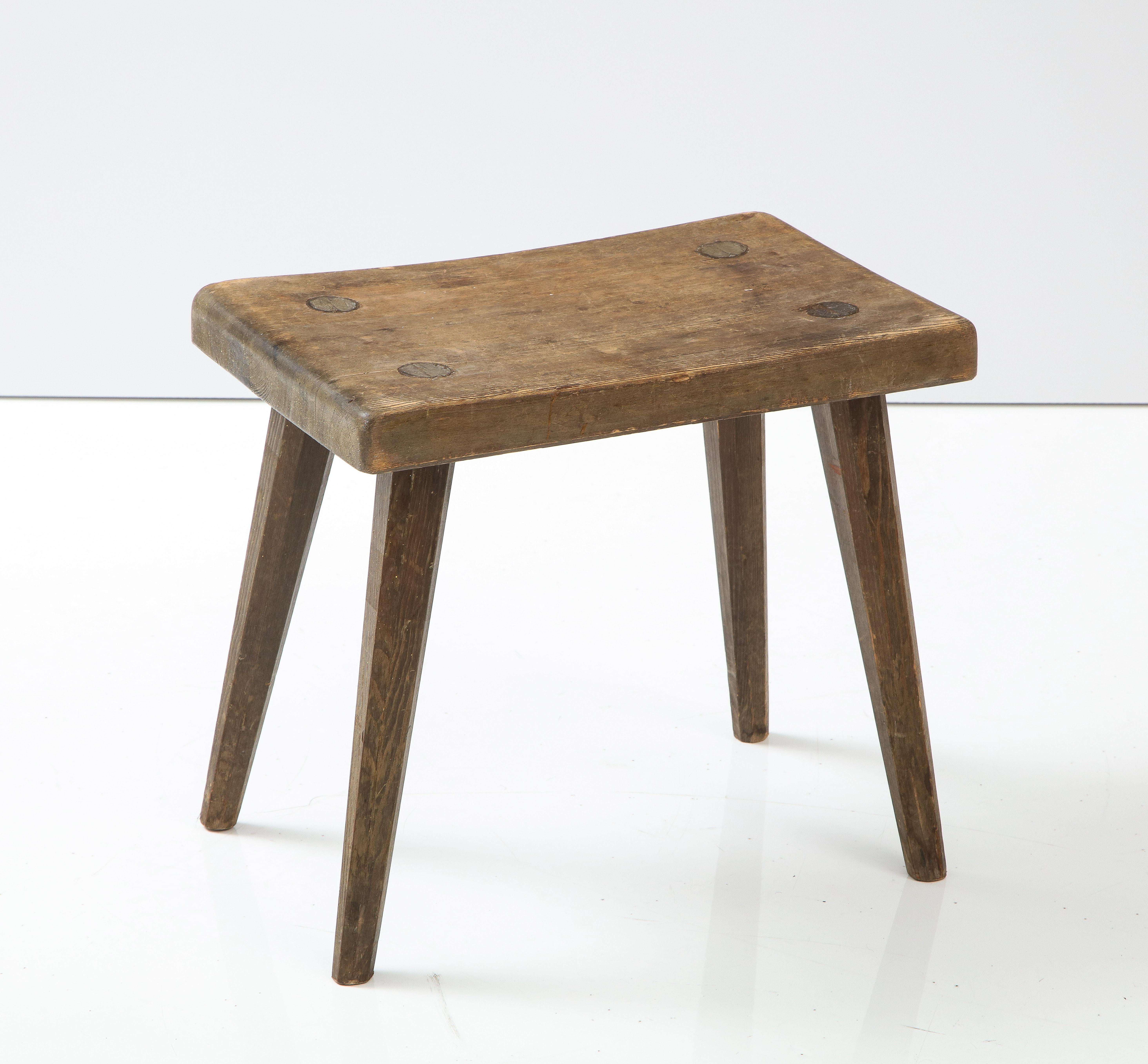 A Swedish solid pine stool with an original finish, Circa 1940s, nice thick top raised on square legs with canted edges.

