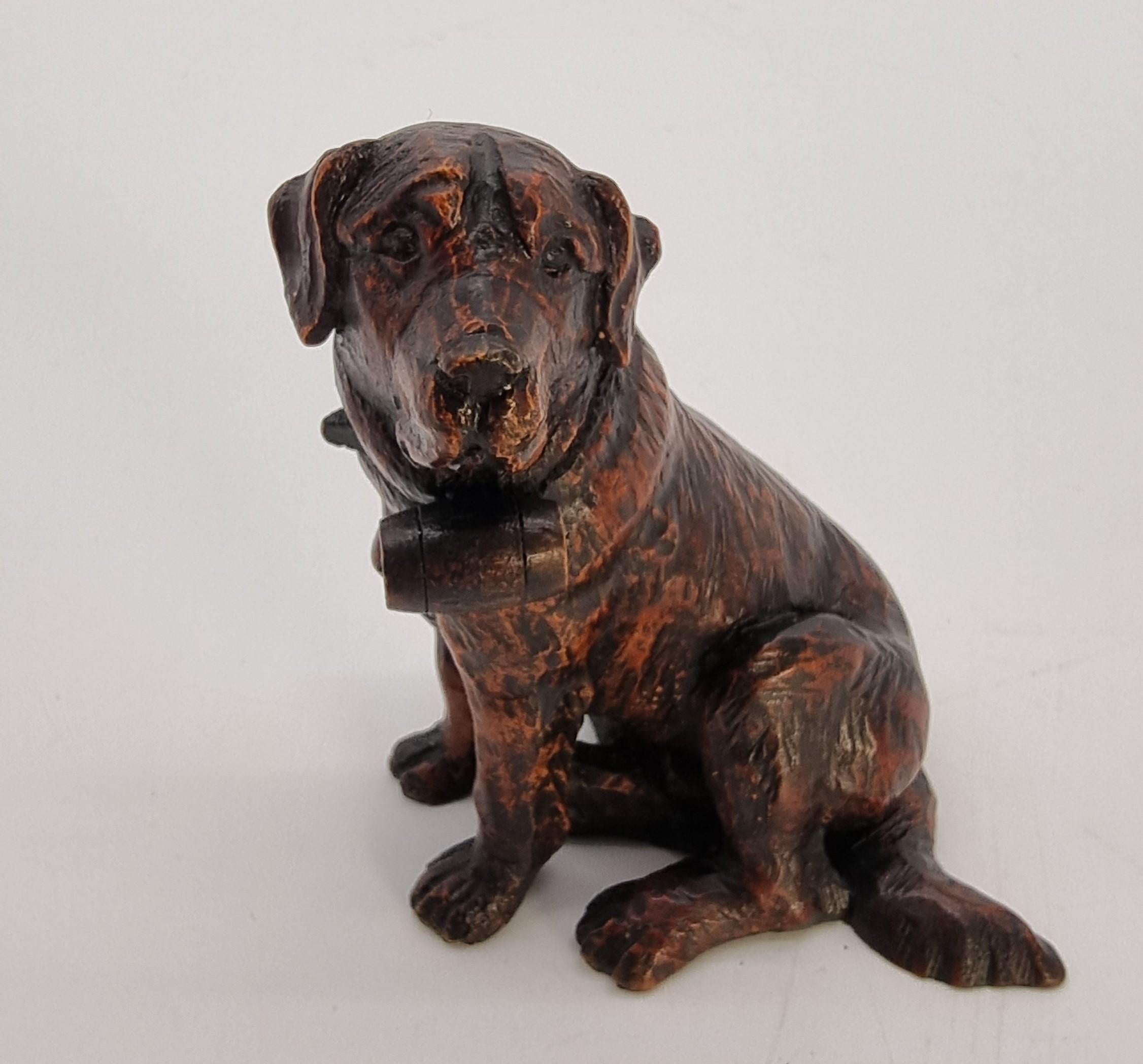 A Swiss Black Forest hand carved limewood study of a St Bernard Mountain rescue dog.

This very pleasing and beautifully hand carved small black forest lime wood study is of a seated St. Bernard Mountain rescue dog with a collar and small wooden