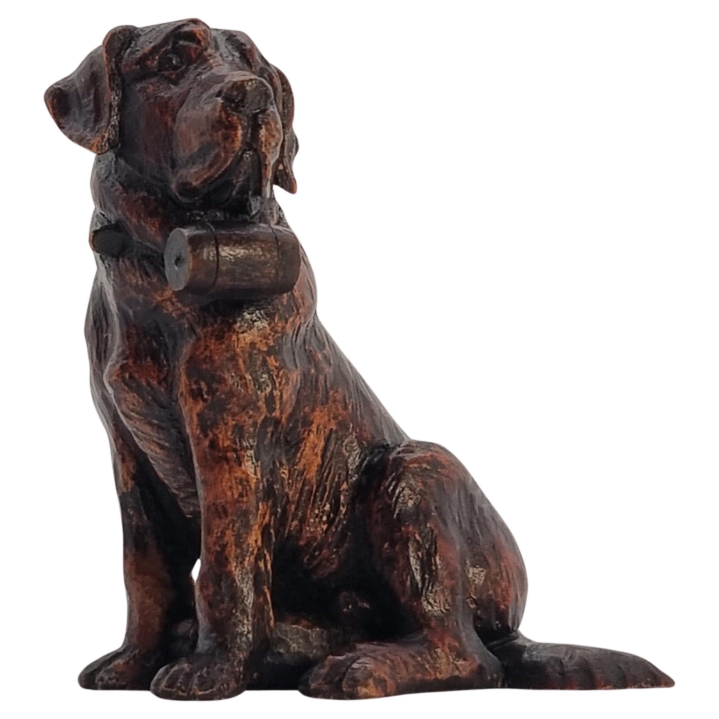 A Swiss Black Forest hand carved wood study of a St Bernard Mountain rescue dog