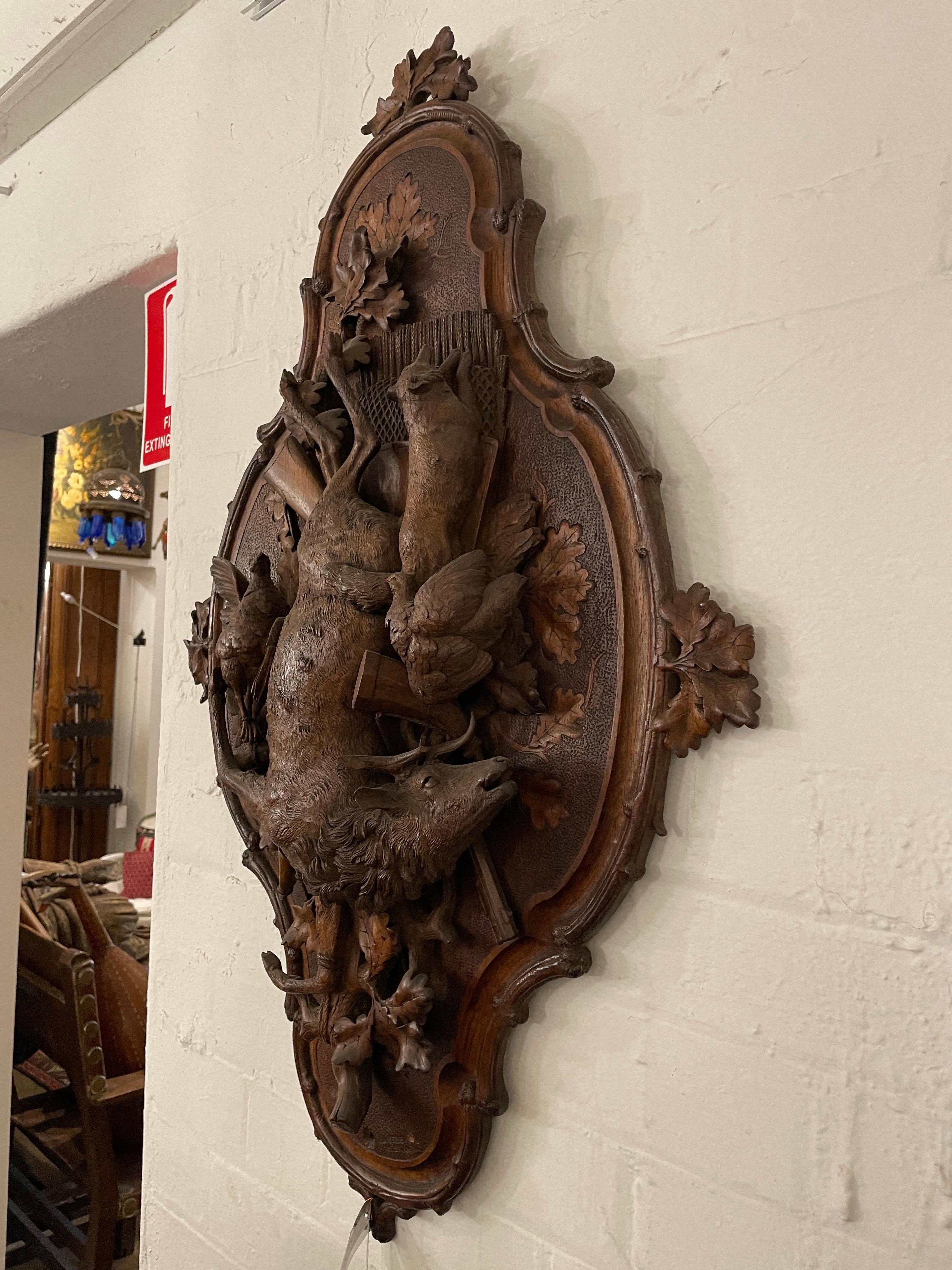 A Swiss Carved Black Forest Hunting Wall Plaque, Early 20th Century							
									
Provenance: Private New South Wales Collection.

Description:
The shield surround centred by a high relief carved buck, fox and fowl, with various other hunting