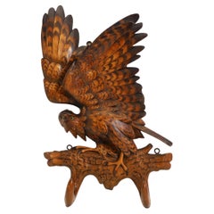 A Swiss Carved Black Forest Linden Wood Coat Hook carved in the form of an eagle