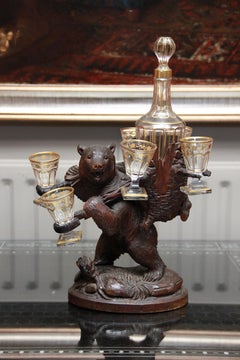 A Swiss Carved Linden Wood Black Forest Bear Liqueur set with gilded decanter an