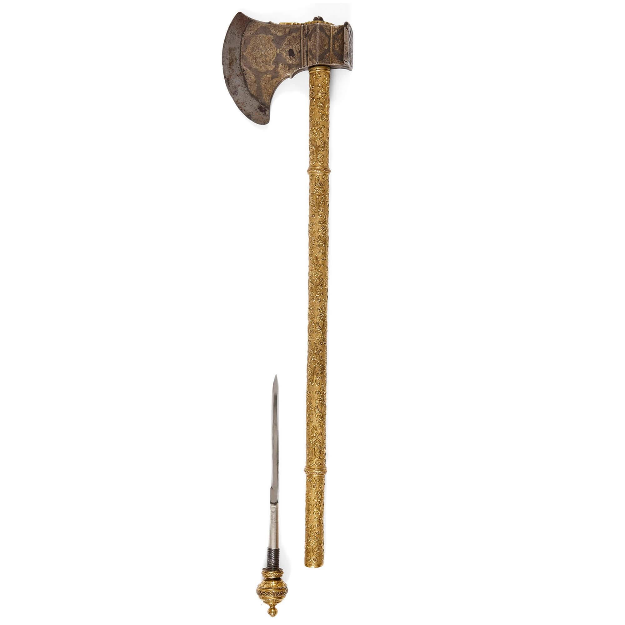 Un Tabarzin, hacha de silla india de Bikaner, siglo XIX
India, siglo XIX
Medidas: altura 56 cm, anchura 12,5 cm, profundidad 4 cm

Esta magnífica pieza es un tabarzin, un hacha de batalla fabricada en el noroeste de la India, en Bikaner, a