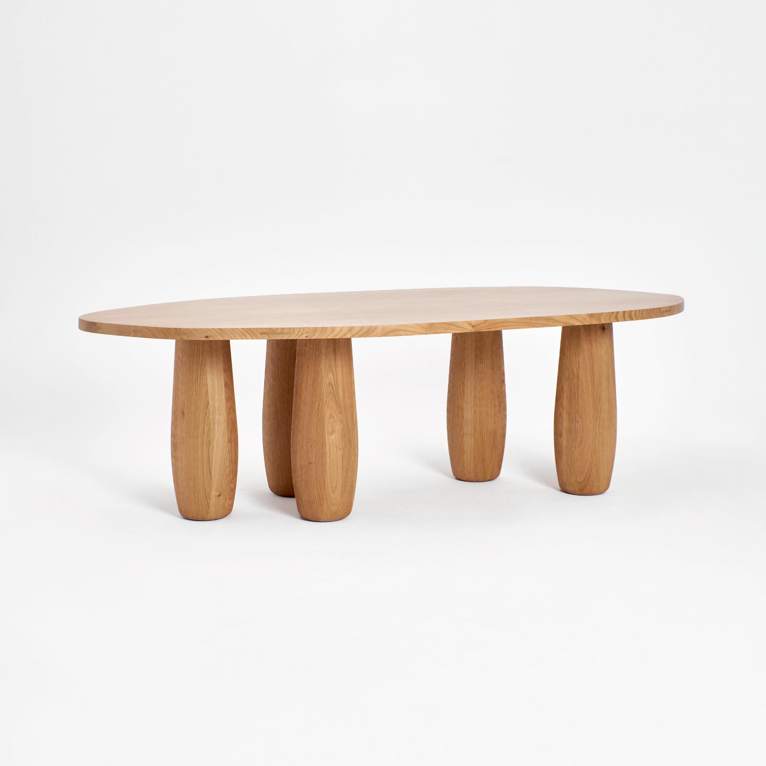 A table dining table by Project 213A
Dimensions: D 117 x W 214.5 x H 76.5 cm
Materials: Cherry wood. 

An asymmetric table top standing on five oval legs. Each segment carved from an individual piece of cherry wood to showcase the natural flow and