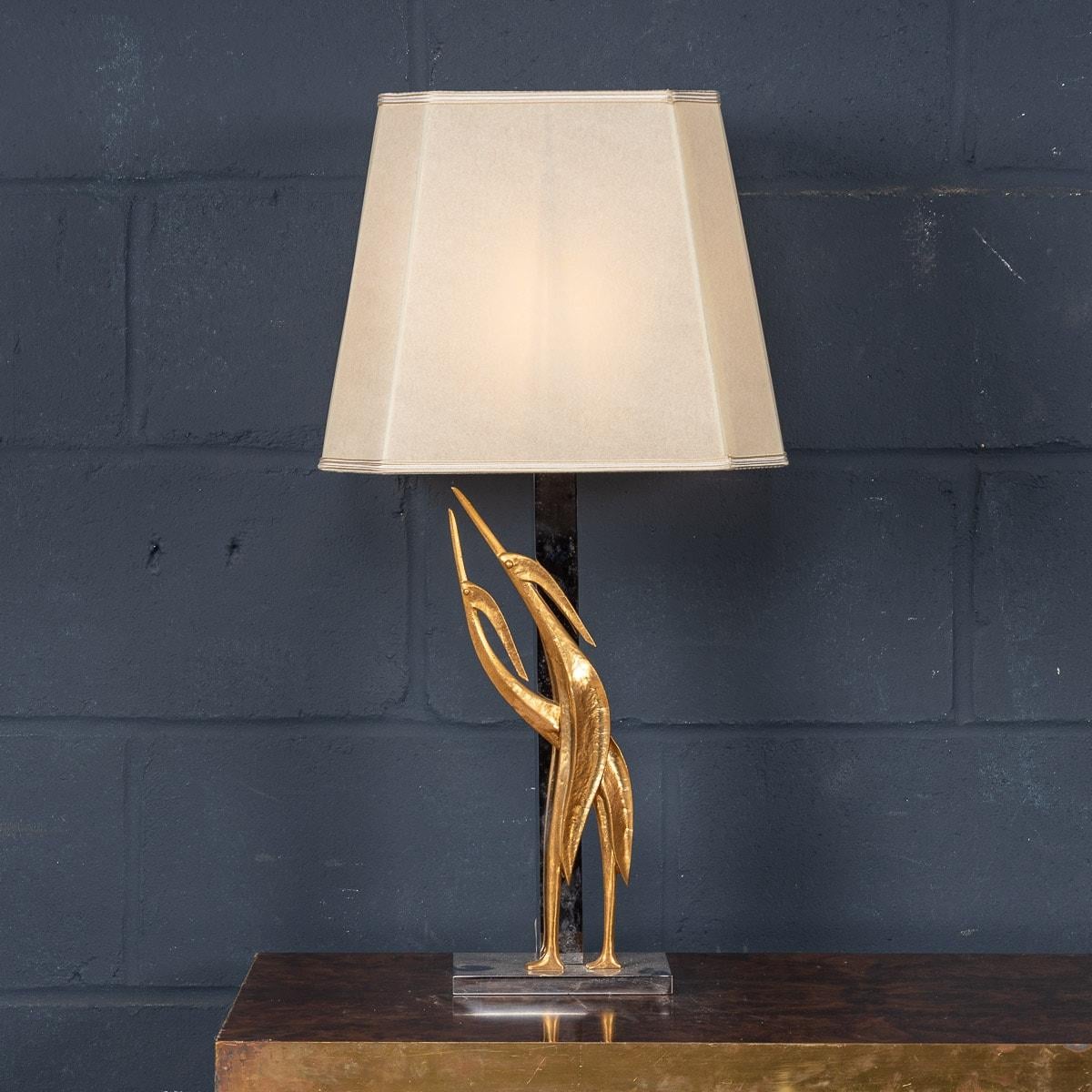 An exceptional late 1970s / early 1980s Hollywood Regency table lamp by Lanciotto Galeotti for L' Originale, in Florence, Italy. An extremely high quality gilded bronze and chrome sculpture, the stem of the lamp has an applied heron, typical of