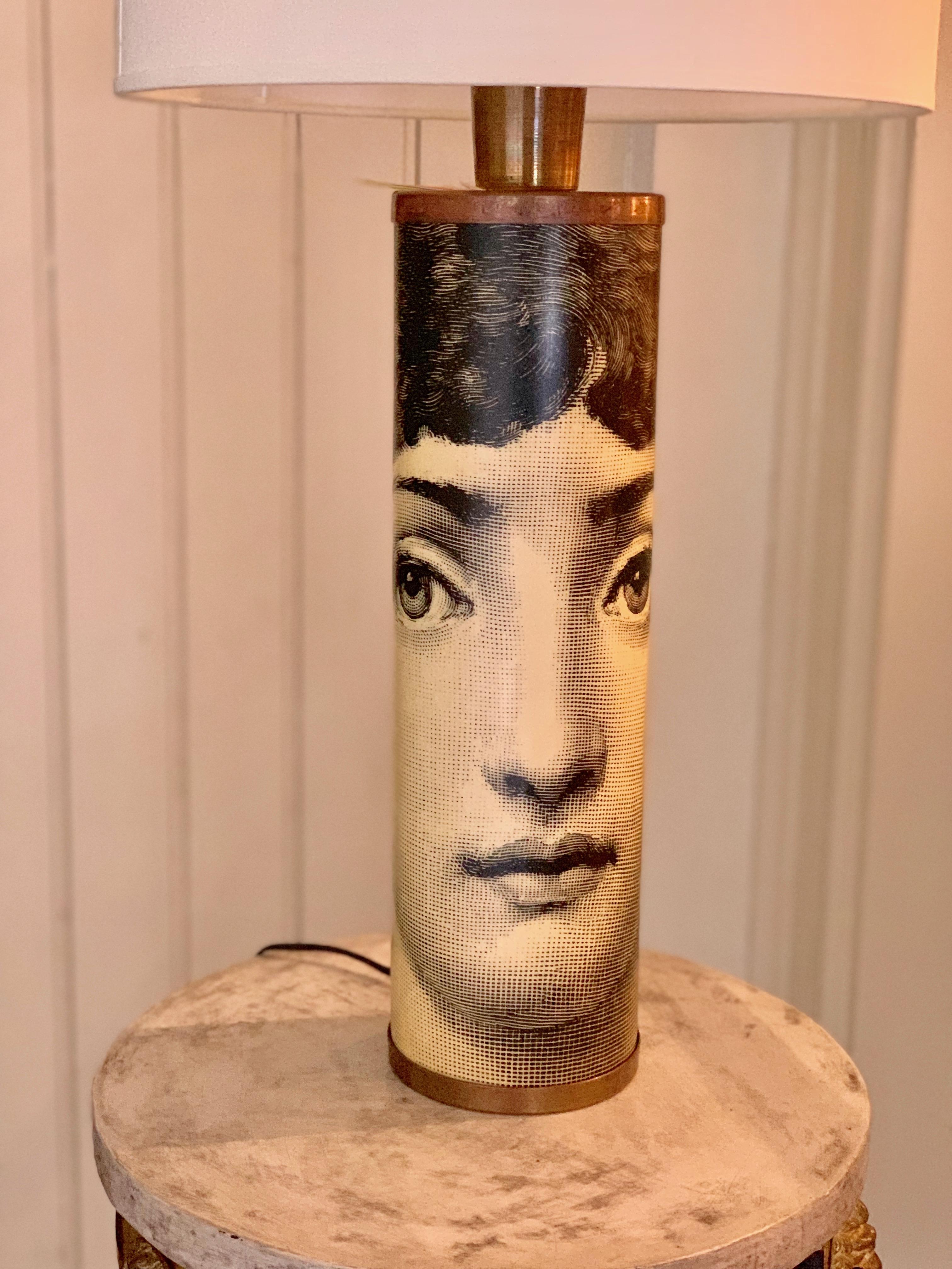 A table lamp designed by Fornasetti featuring the image of famed opera singer Lina Cavalieri screen-printed around the base. Once called the 