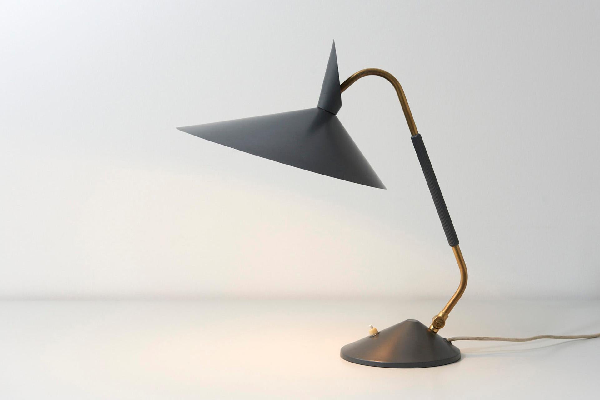A 1950s desk lamp in brass with grey lacquered lamp shade in the style of S.A. Holm Sørensen.