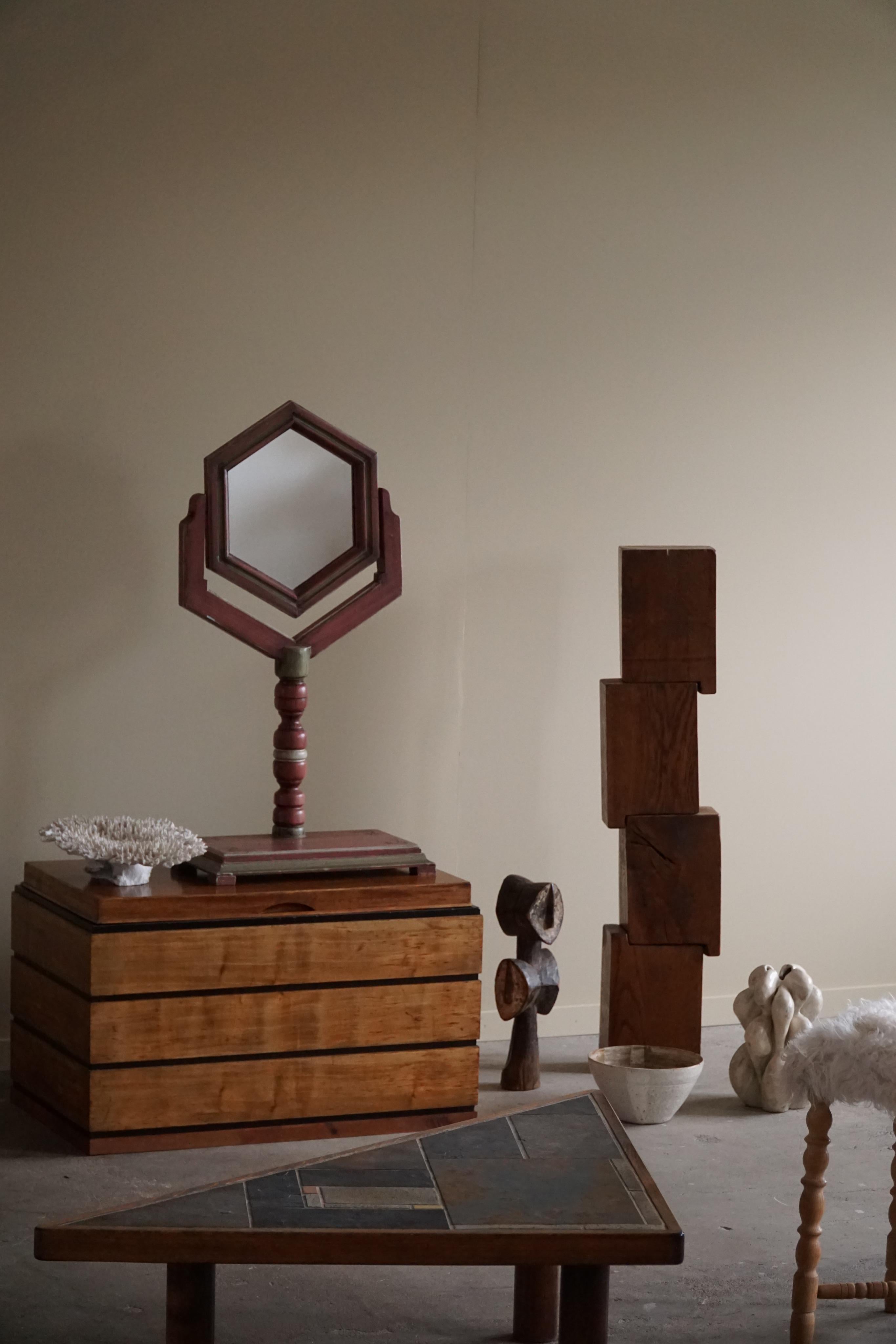 Ce charmant miroir de table en pin de forme hexagonale est un superbe exemple de l'art populaire suédois du début des années 1900. Le miroir est fabriqué en bois de pin massif avec une belle peinture patinée. Il capture l'essence de l'artisanat