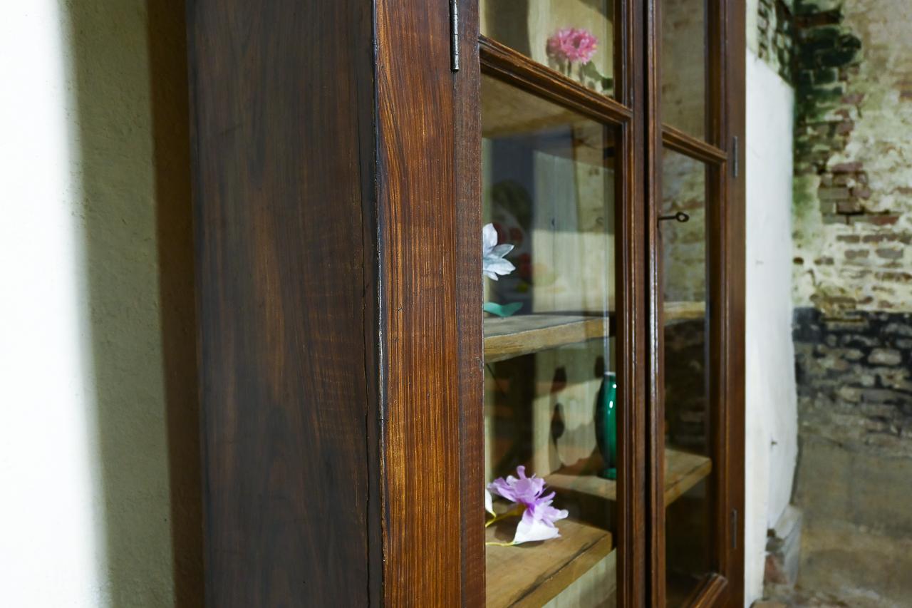 A majestic 19th century French Bibliothèque, of very tall and slender proportions. 
Demonstrating a pair of glazed upper doors, retaining their original glass above a pair of panelled doors. Featuring well-executed Faux Bois in the form of