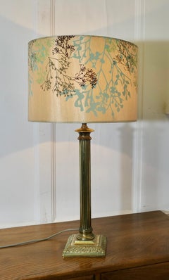 A Tall Brass Corinthian Column Table Lamp with Shade