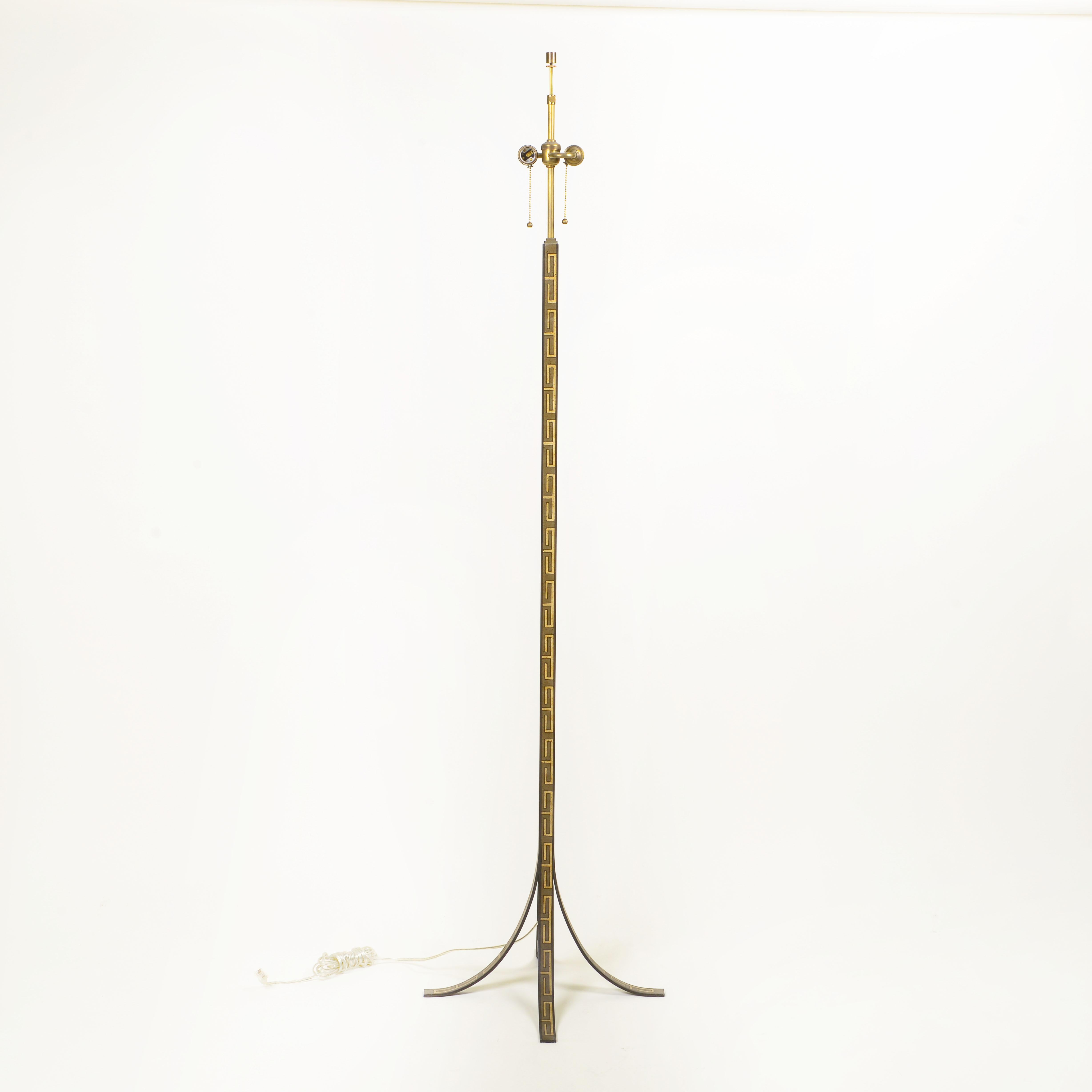 Hand-painted with intricate Greek key decoration, this floor lamp is supported on four downswept feet. With paper drum shade.