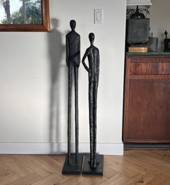 A tall pair of Giacometti style figurative floor sculptures, 20th century