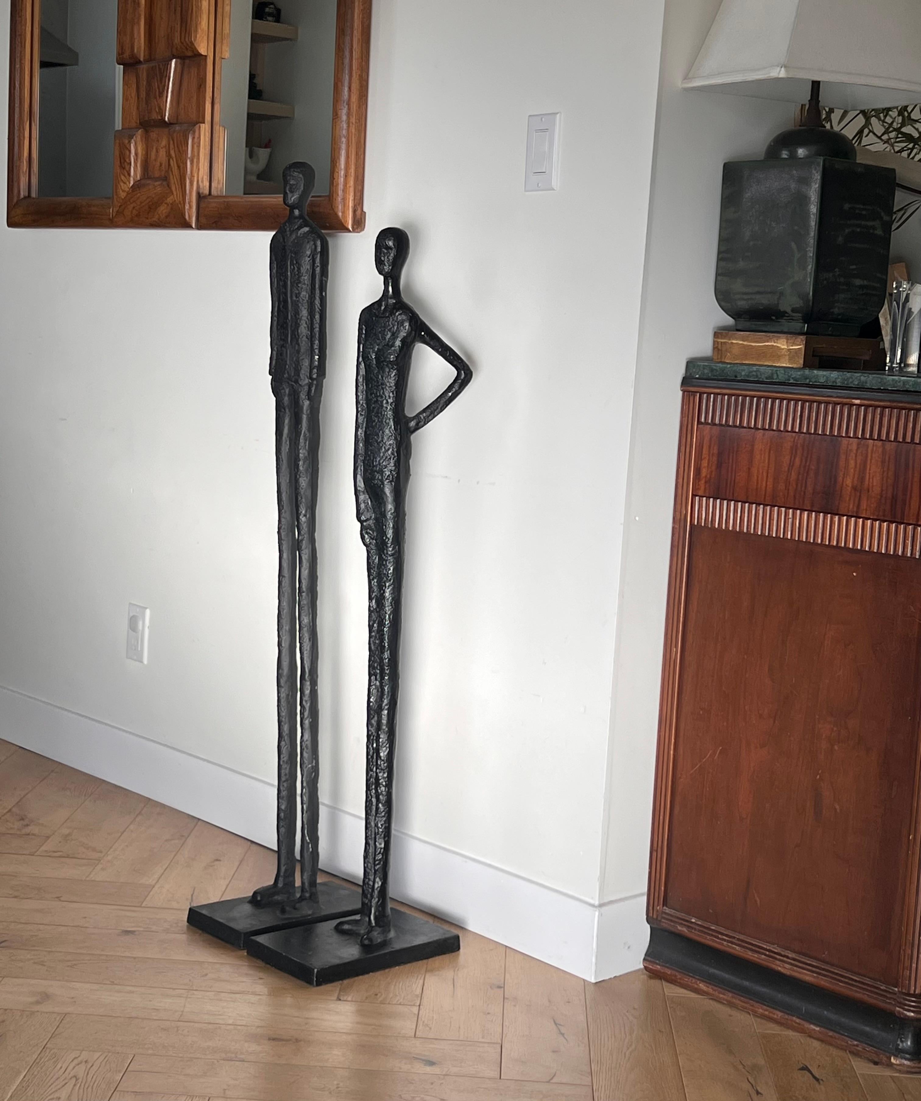 Metal A tall pair of Giacometti style figurative floor sculptures, 20th century 