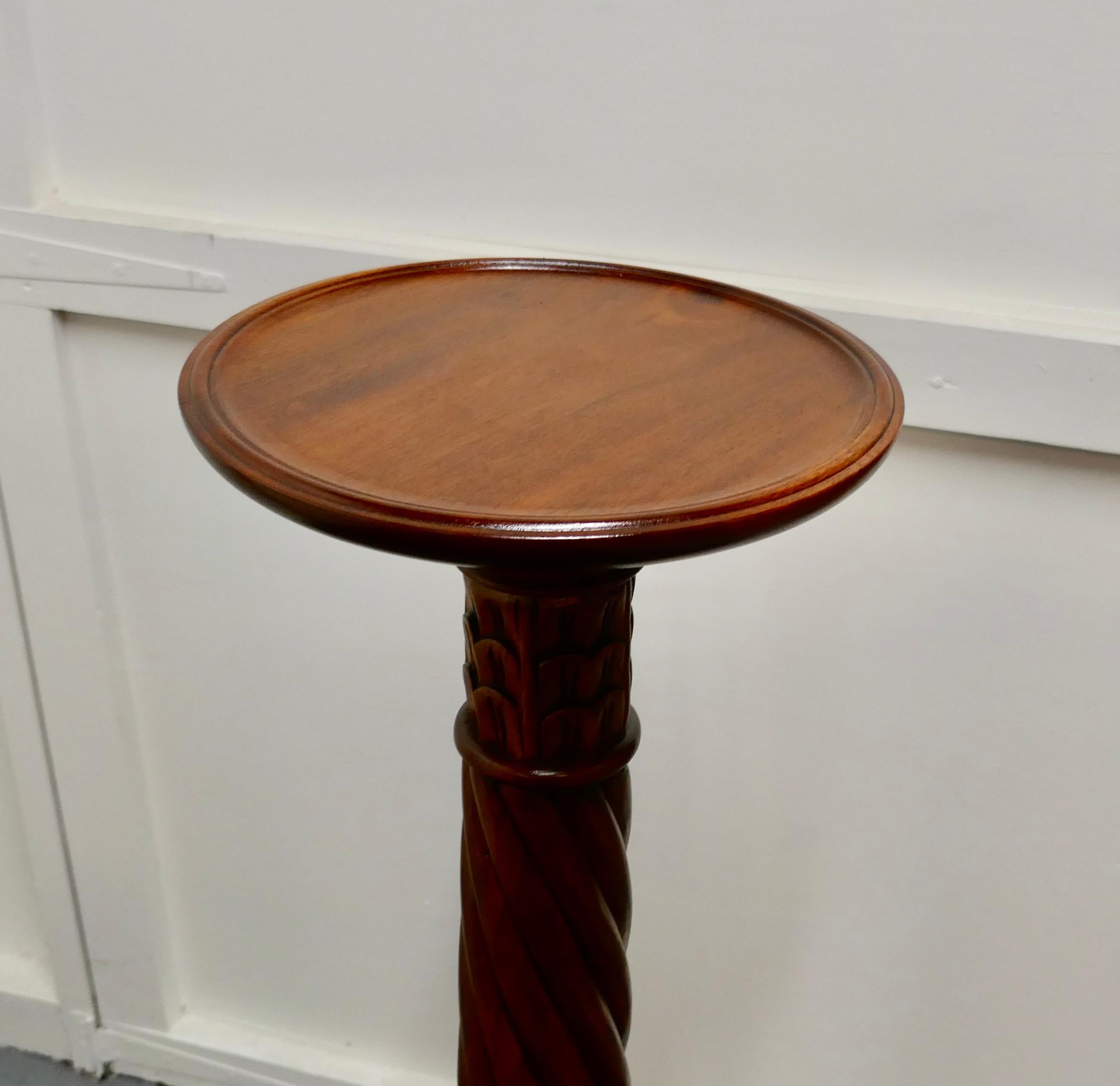 A tall pair of mahogany torchère or lamp stands

This is a fine quality pair of mahogany torchère they have a circular flat top with a raised moulded rim. They each stand on a carved 3 footed base with detailed acanthus leaf carving both to the