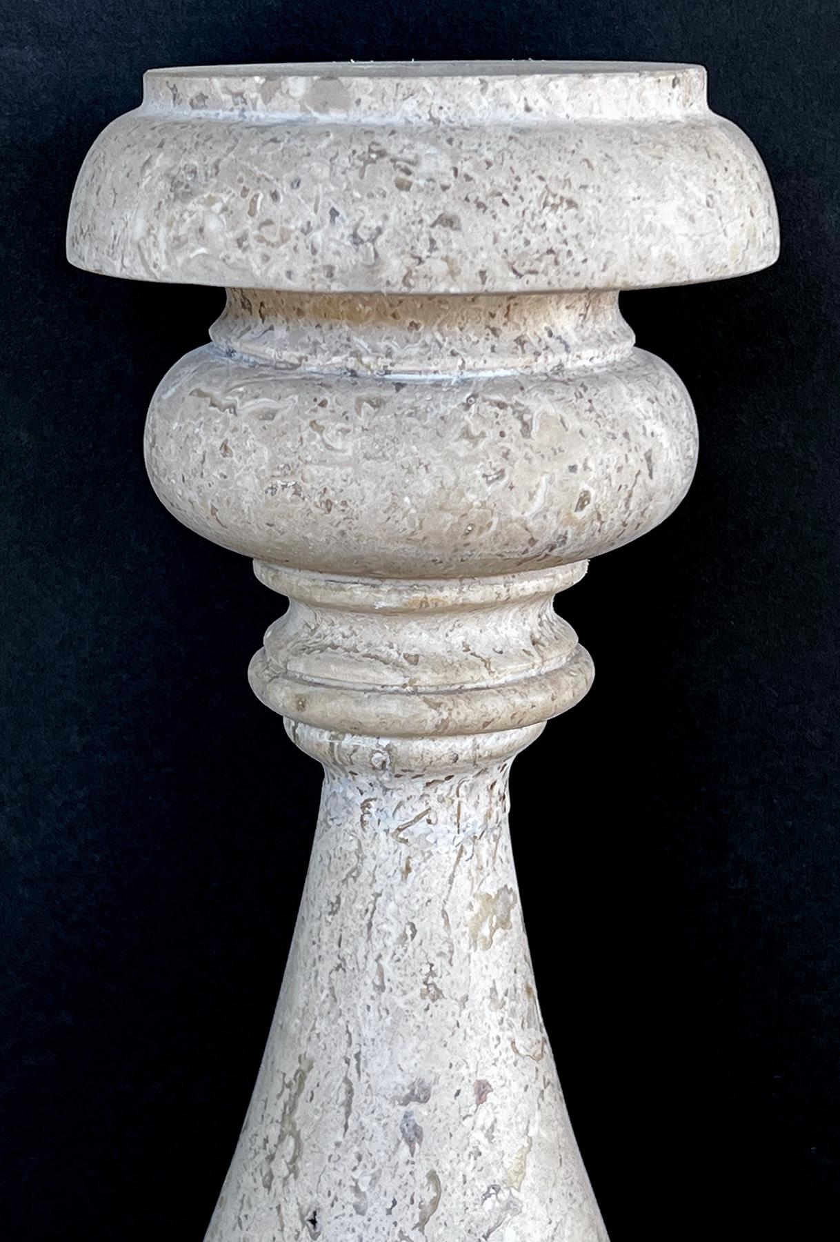 each substantial baluster-form lamp of carved travertine resting on iron bases; from the collection of Craig Wright, Los Angeles