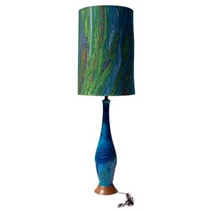 A Tall Slender Lava Glazed Blue Ceramic Lamp with a Tall Psychedelic Drum Shade