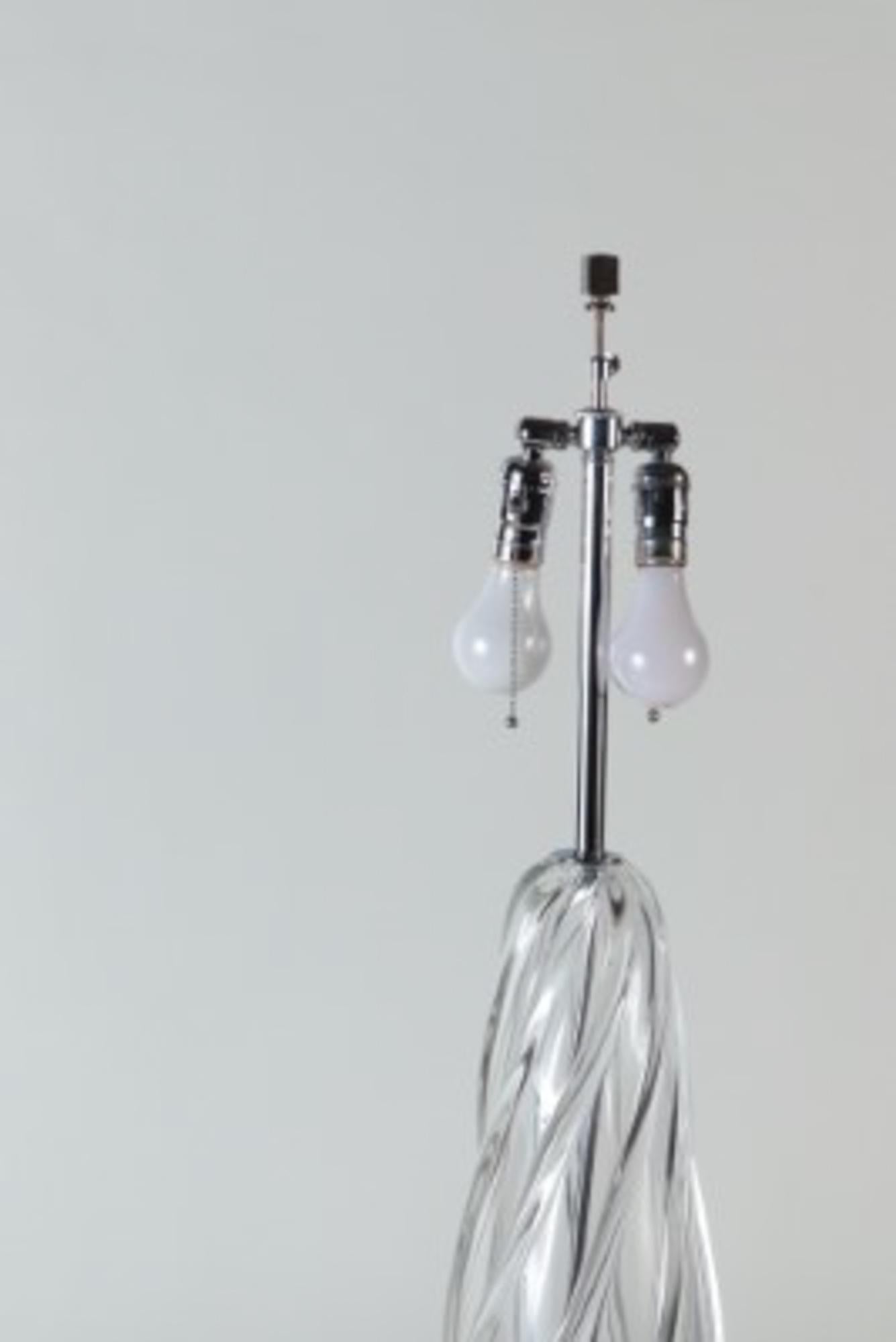 A tall swirl glass lamp on chrome base.
 Base: 5