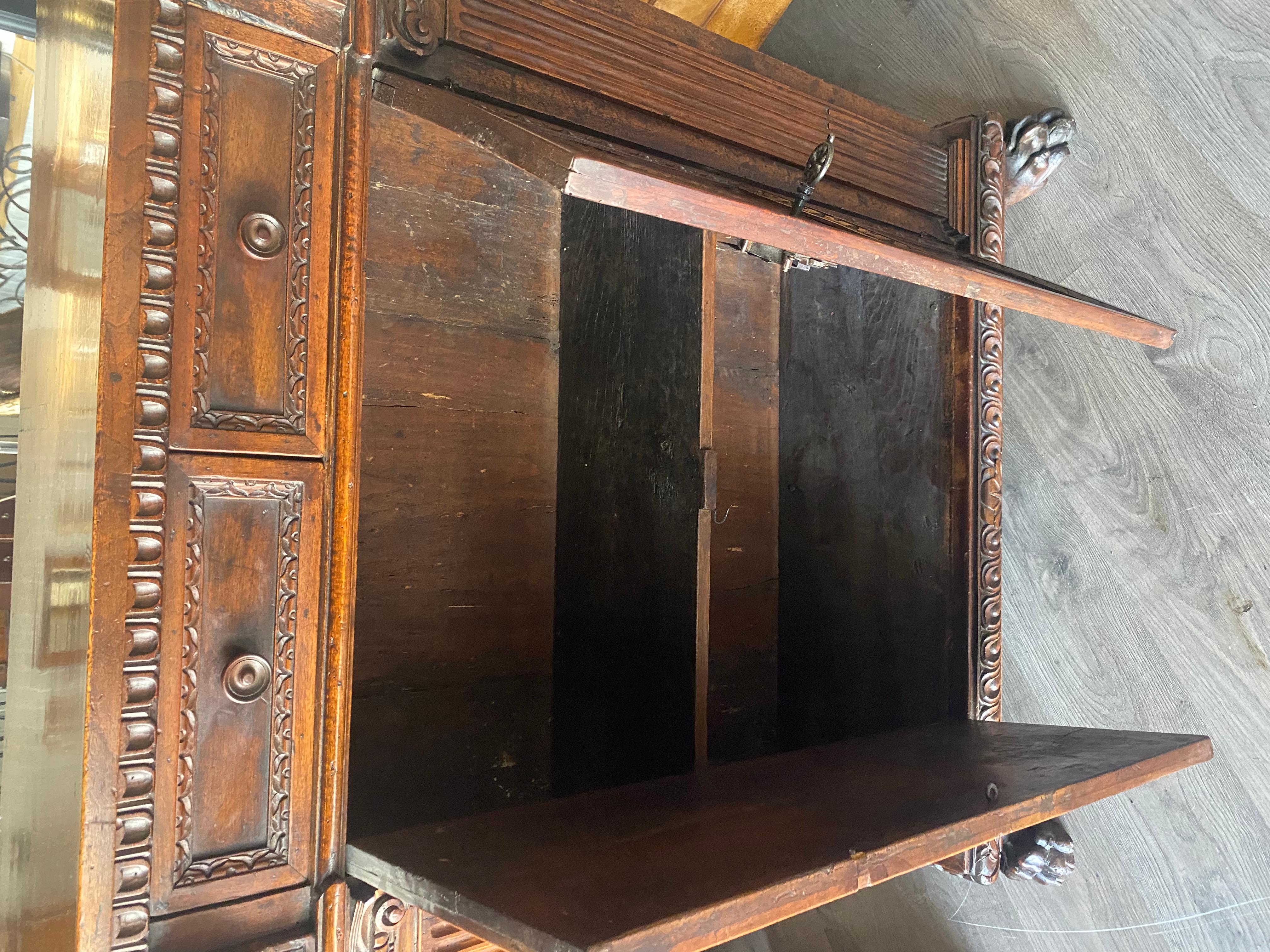 A tall 17th C. walnut cabinet buffet, having a plank top with dentil moulding. For Sale 4
