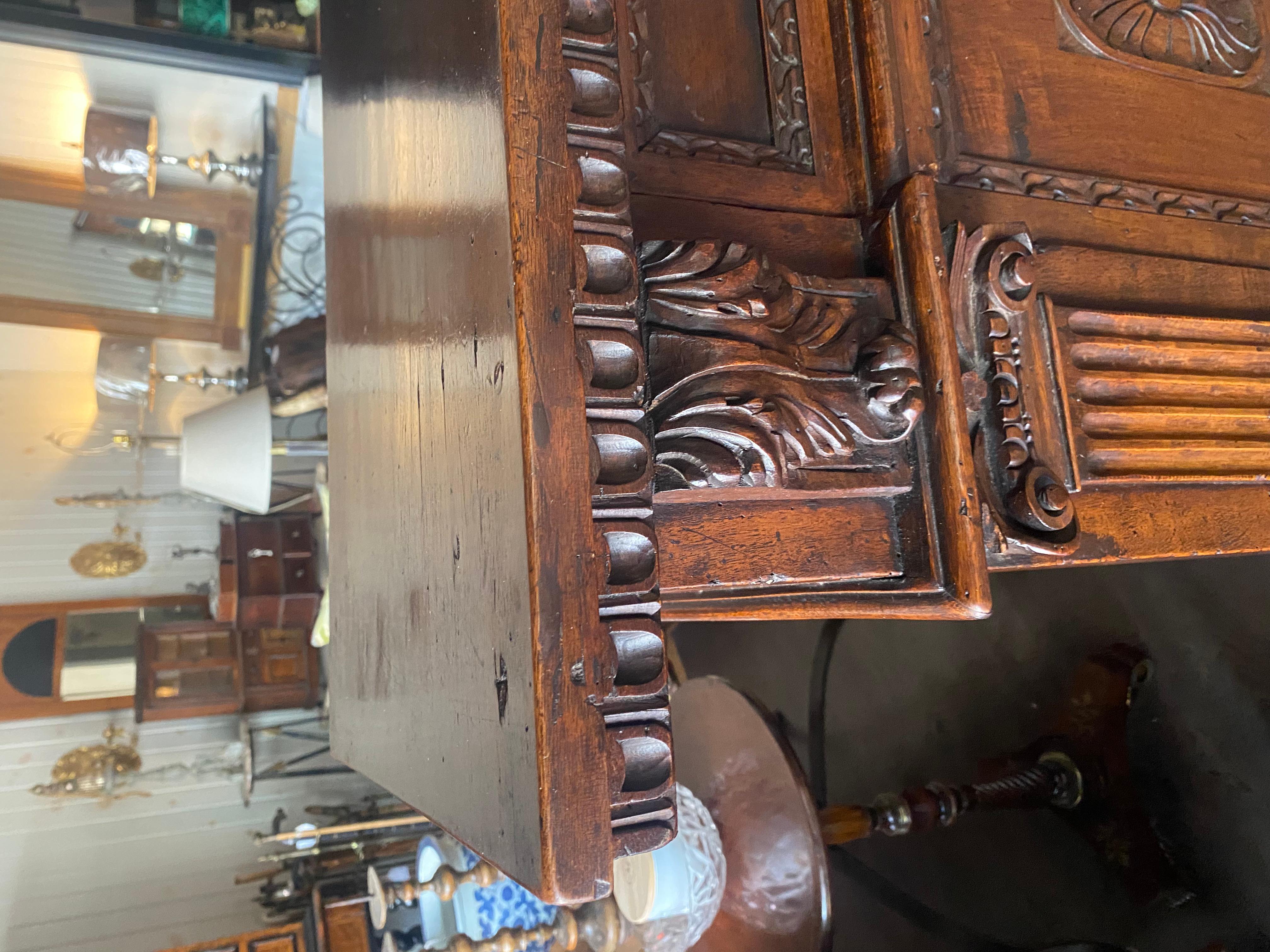 Italian A tall 17th C. walnut cabinet buffet, having a plank top with dentil moulding. For Sale