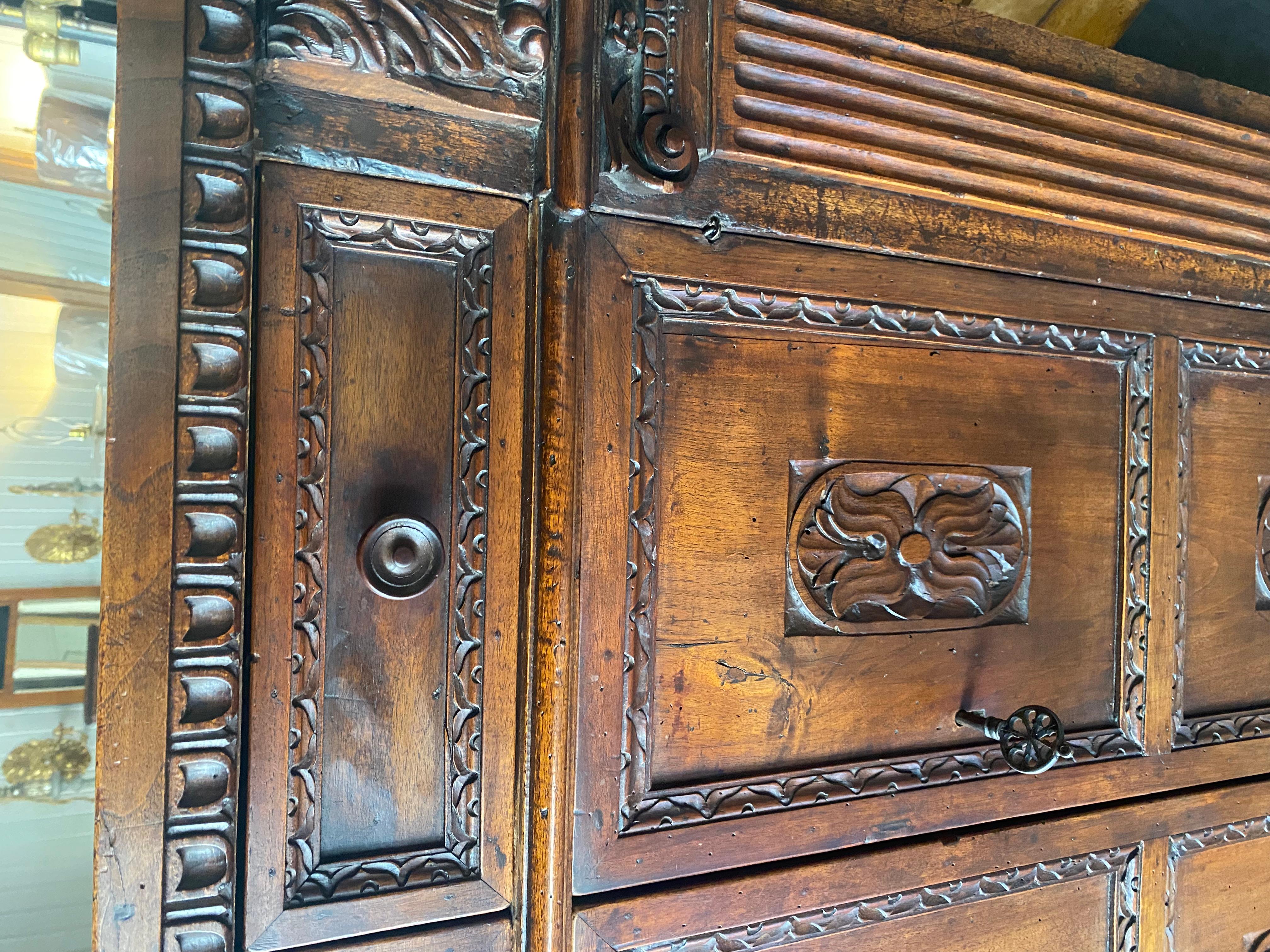 18th Century and Earlier A tall 17th C. walnut cabinet buffet, having a plank top with dentil moulding. For Sale
