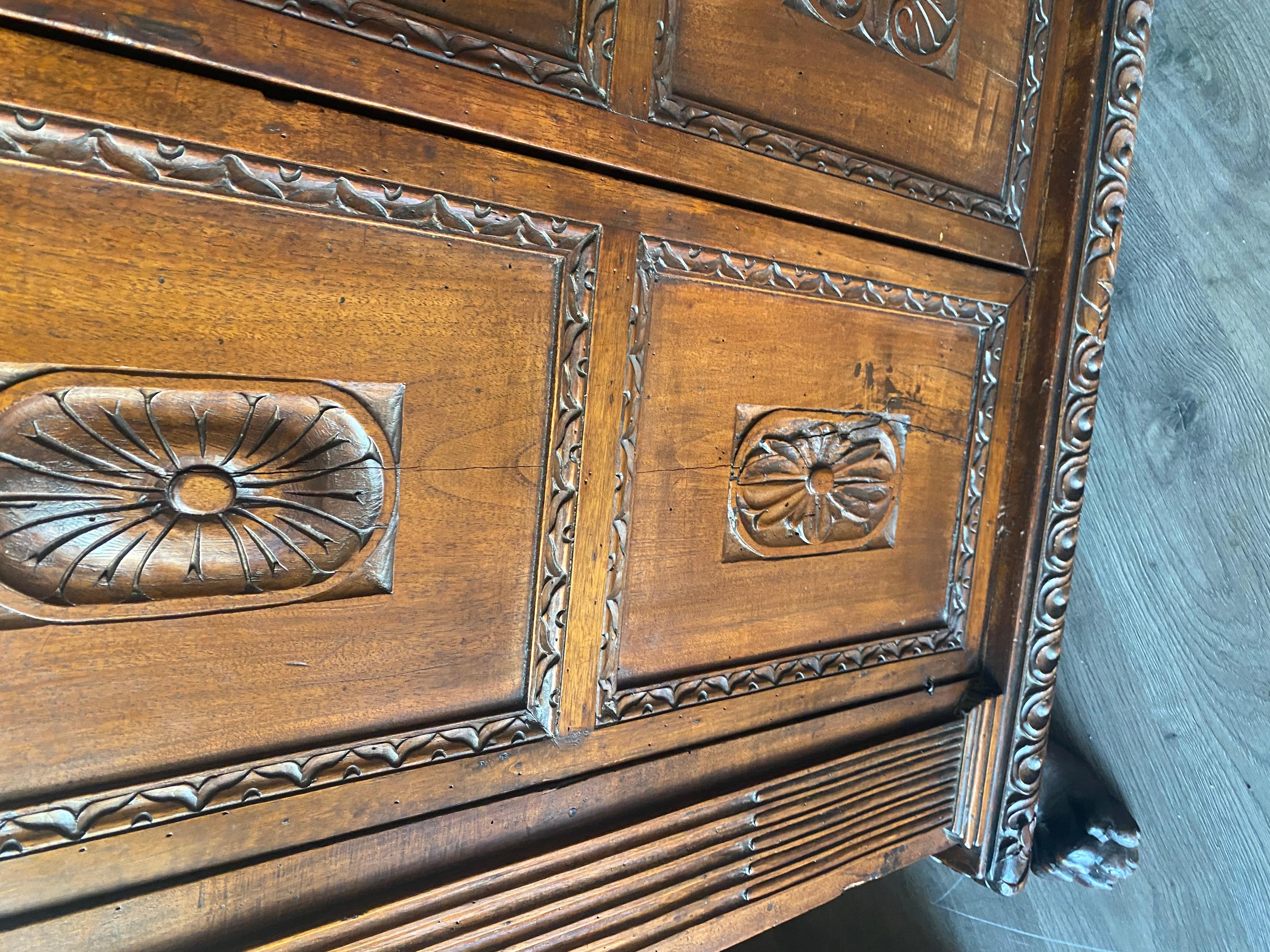 A tall 17th C. walnut cabinet buffet, having a plank top with dentil moulding. For Sale 1