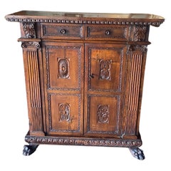 A tall 17th C. walnut cabinet buffet, having a plank top with dentil moulding.
